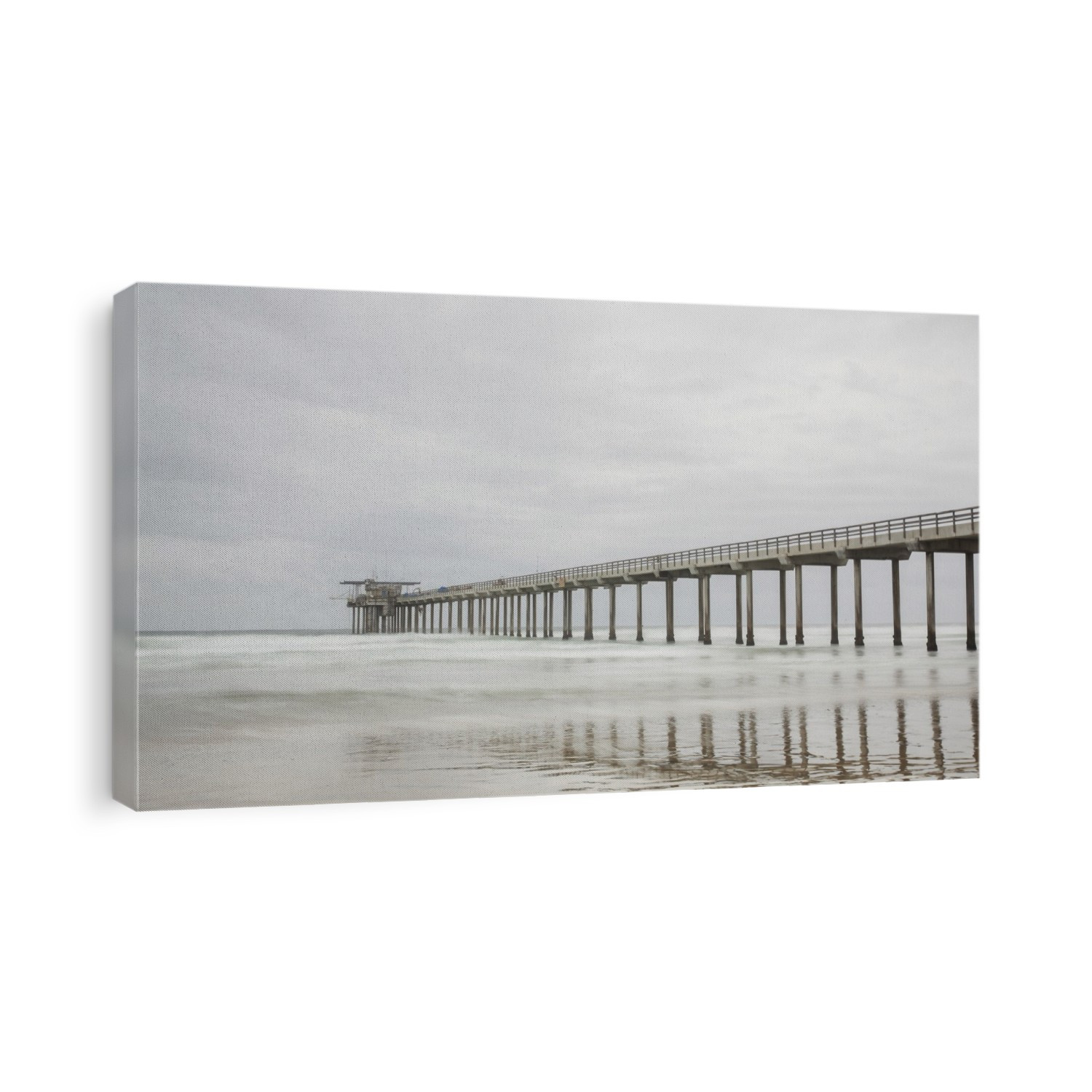 The long expanse of the iconic Scripps Pier in the Pacific Ocean near San Diego on a grey day; La Jolla, San Diego County, California, United States of America