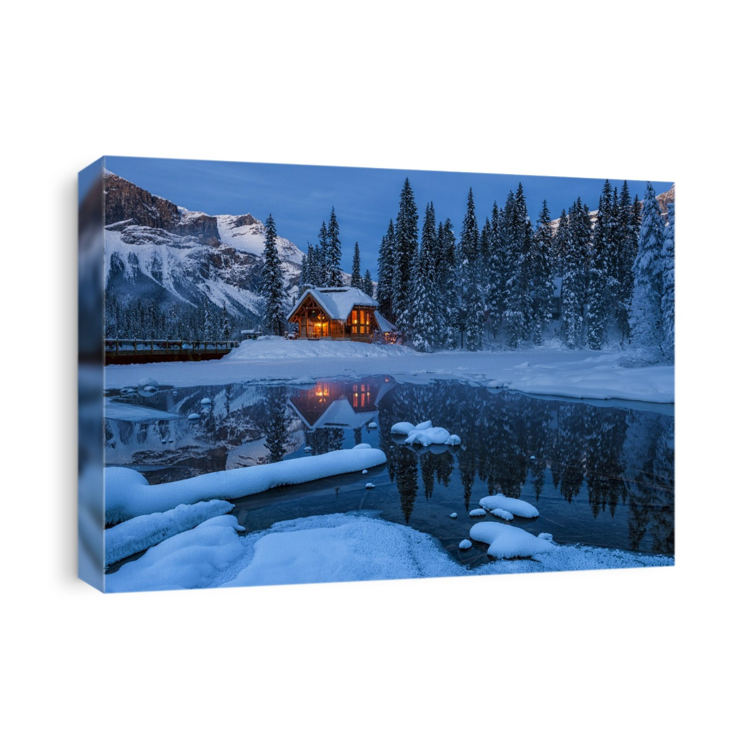 Emerald Lake Lodge reflected in Emerald Lake backed by President range at night in the Canadian Rockies.