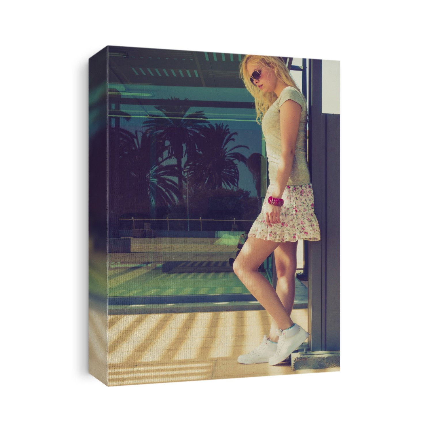 Young woman wearing mini skirt standing by wall.