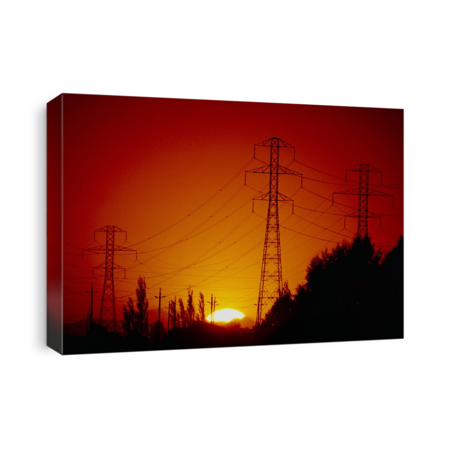 Electricity pylons at sunset. These pylons carry the high tension (high voltage) supplies of national grid systems from the power stations to local distribution sub-stations. Photographed in British Columbia, Canada.