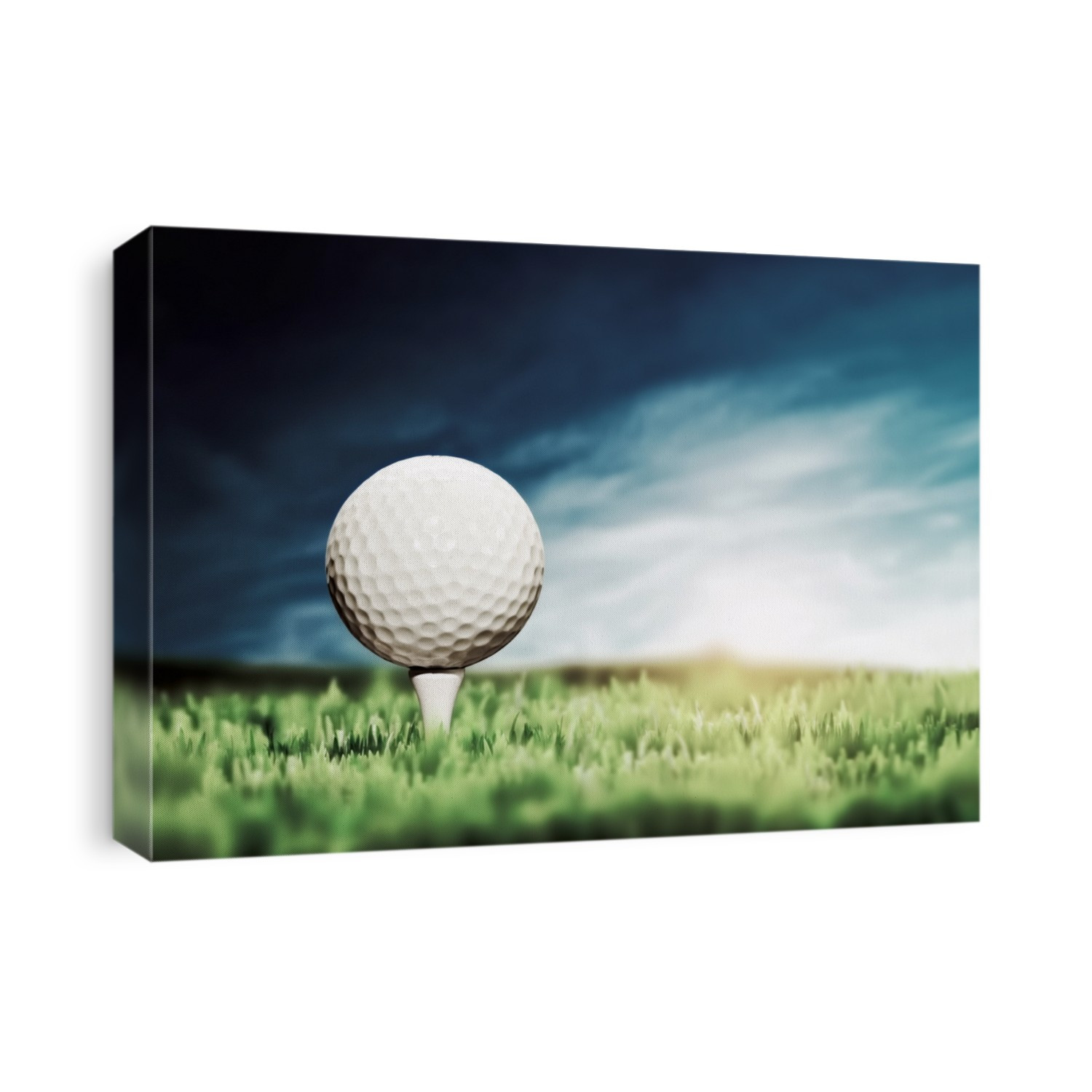 Golf ball placed on white golf tee on green grass golf course. Moody sunny sky.