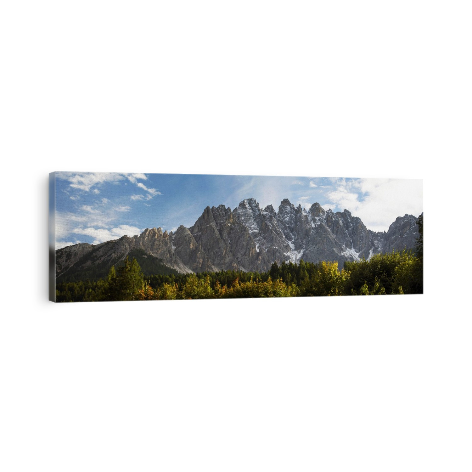 Panorama of jagged mountain range with glowing trees in the foreground; San Candido, Bolzano, Italy