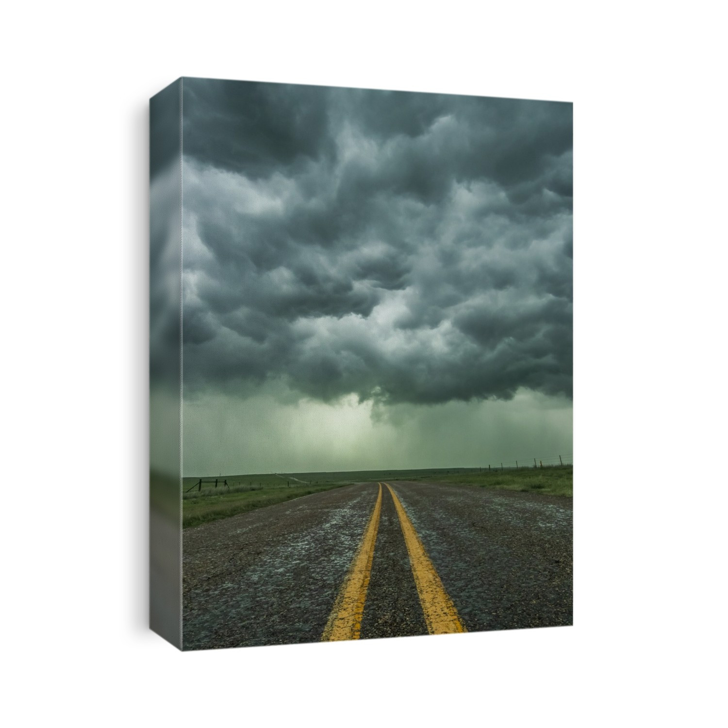An empty highway disappears into the mouth of a storm somewhere in the Texas Panhandle; Texas, United States of America