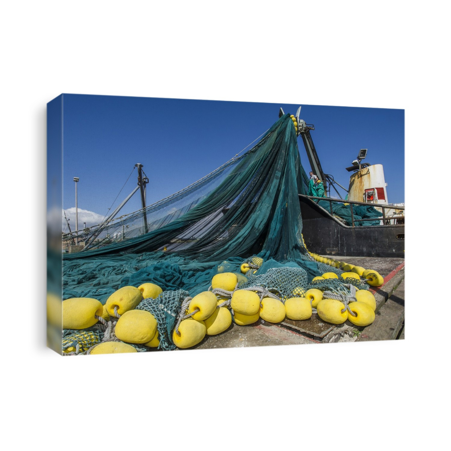 Purse seine fishing net being loaded onto a boat. A purse seine net is a large circular net that can be pulled together at the bottom to prevent fish from swimming down and out of the net. It is used to catch fish that school near the surface, such as mackerel and anchovies. Photographed on the Berg River, Western Cape, South Africa.