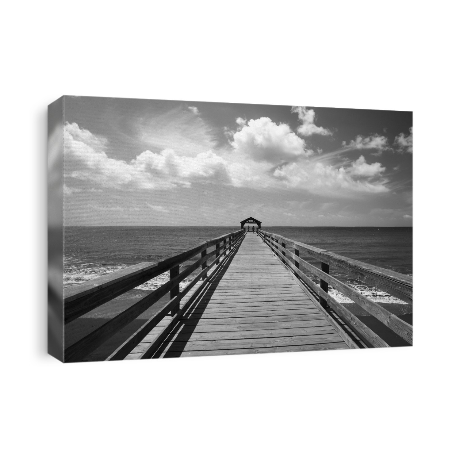 Black and white image of a pier leading out to the ocean water with a covered area at the end; Hanalei, Kauai, Hawaii, United States of America