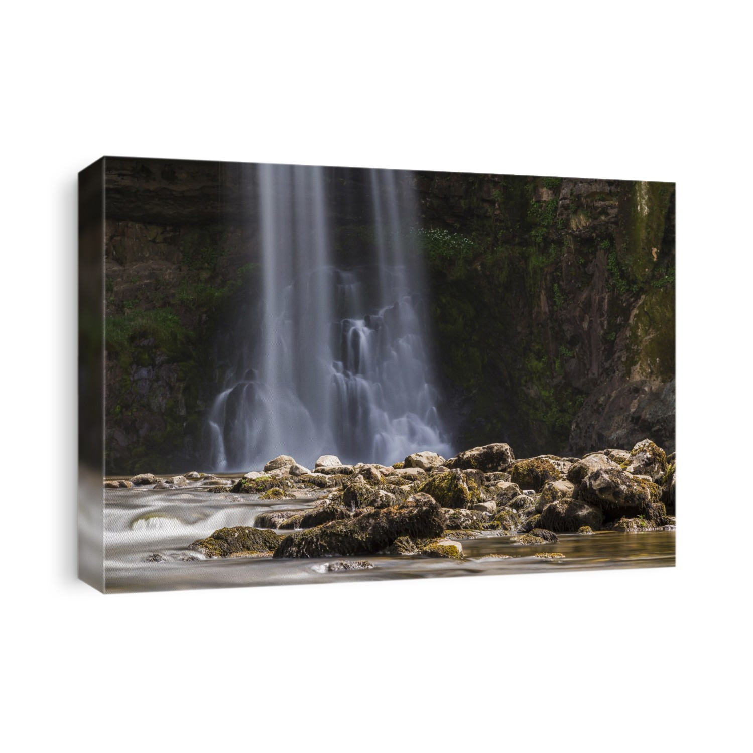 Water falling from a tall cascade along the Ingleton waterfalls trail in North Yorkshire.