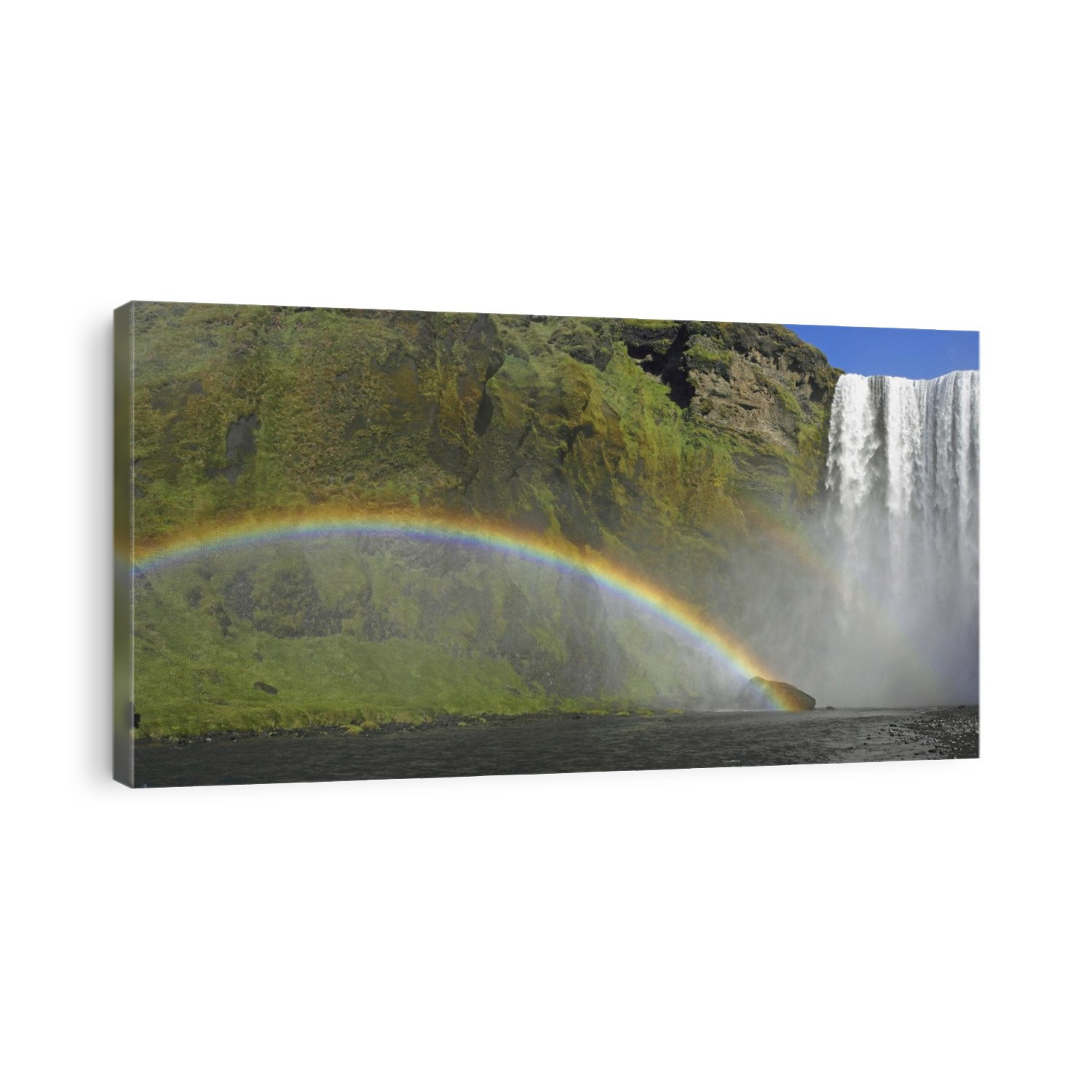 Skogafoss waterfall, Iceland. A rainbow is at lower left. This waterfall falls over cliffs that mark where the former Icelandic coastline existed. One of the largest waterfalls in Iceland, it is 25 metres wide and has a drop of 60 metres.