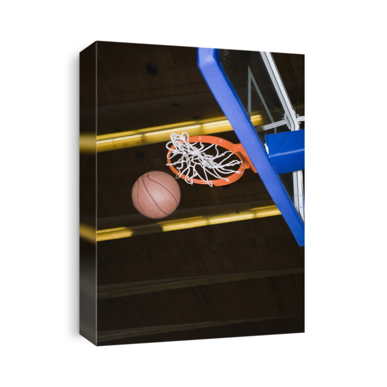 Basketball falling through the net.