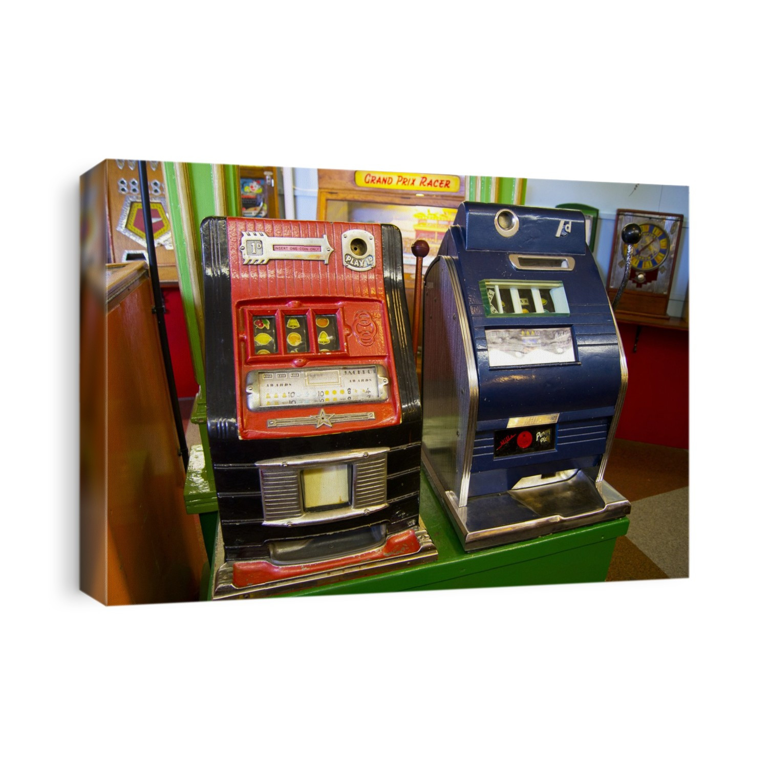 Historic amusement arcade gambling machines featuring the classic bells and fruit icons which need to line up to win. Both machines require an old British (1d) penny to operate.