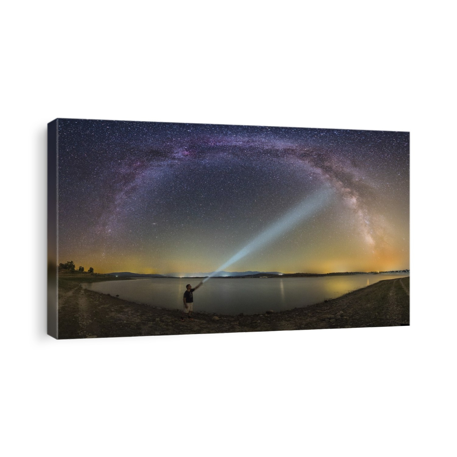 Shining light on the Milky Way. Photographer shining a torch on the band of the Milky Way, arching across the sky. The Milky Way is our galaxy seen from the inside, forming a band of stars and nebulae stretching across the sky. Photographed by a lake in the Gabriel y Galan swamp, Extremadura, Spain.