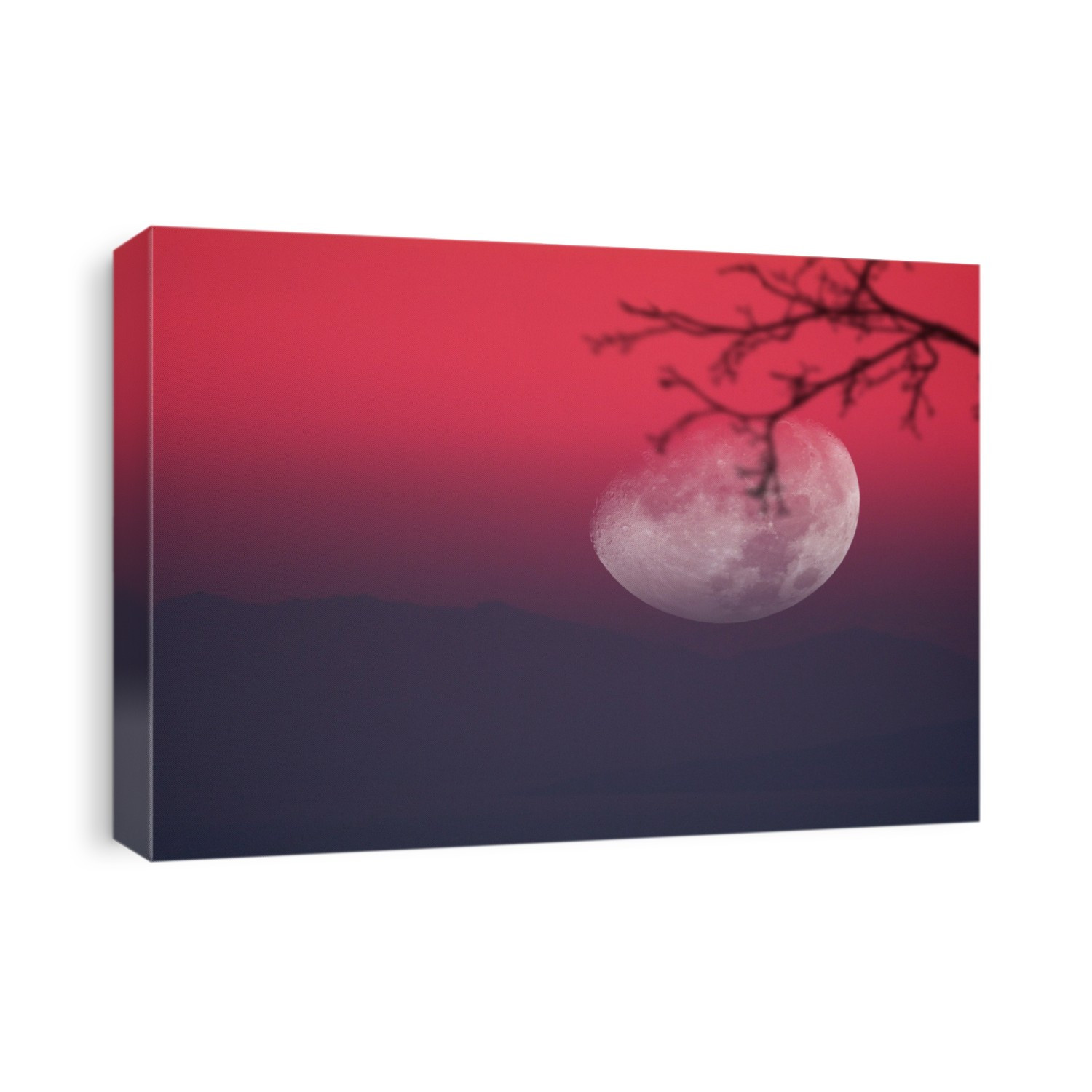 Moon setting behind mountains