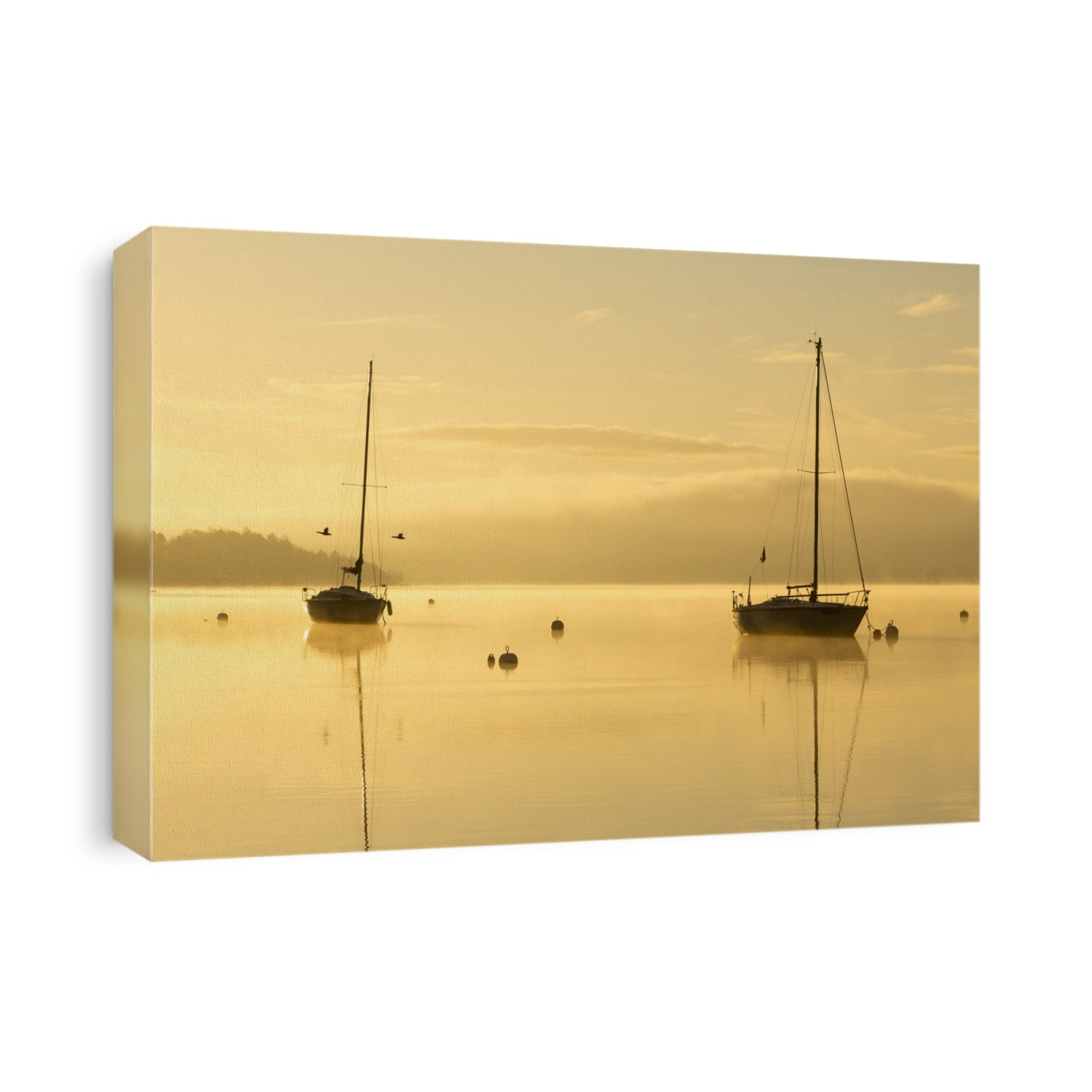 Sunrise over sailing boats on Lake Windermere in Ambleside, Lake District, UK.