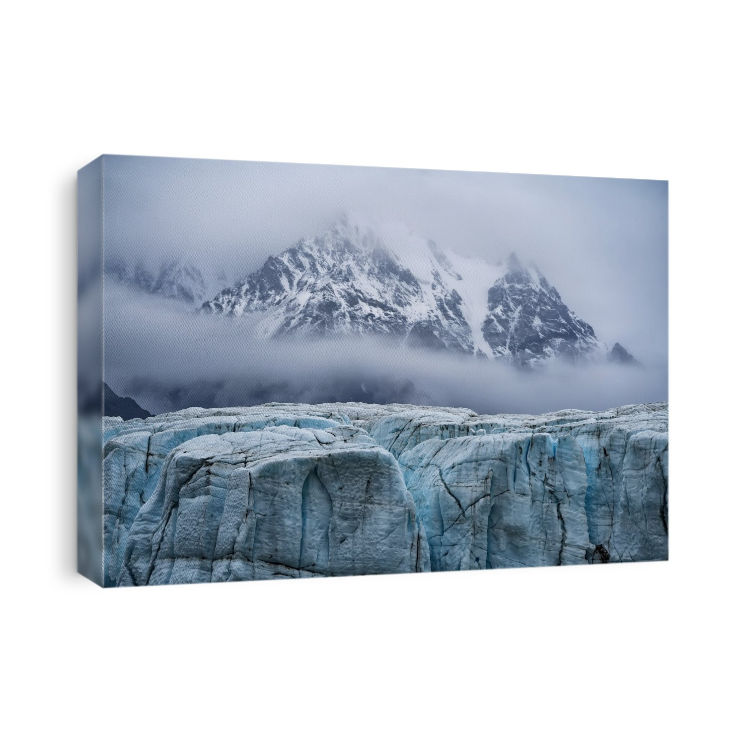 Misty clouds surround the mountaintops and ancient glacial ice at Kluane National Park; Yukon, Canada