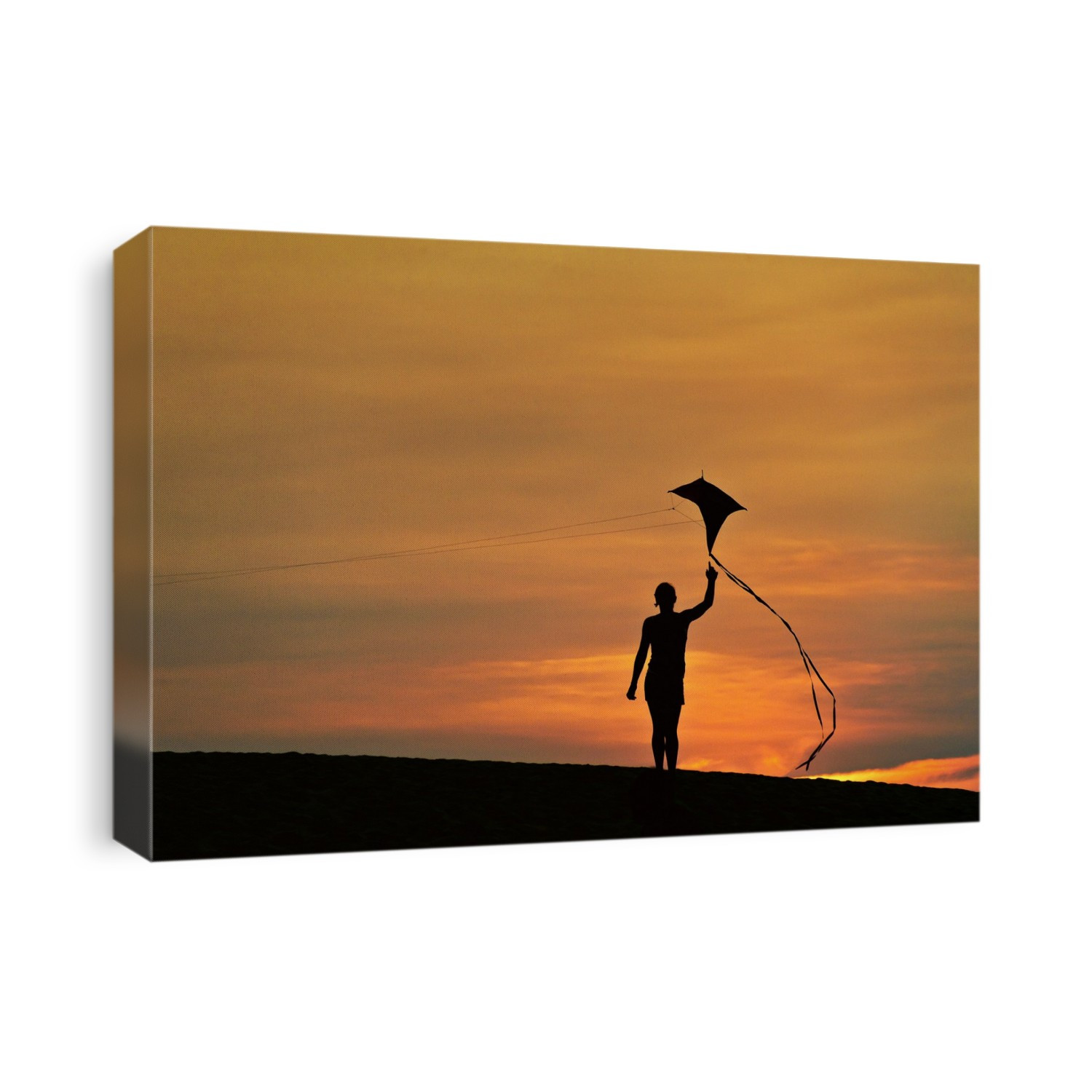 Child flying a kite at sunset.