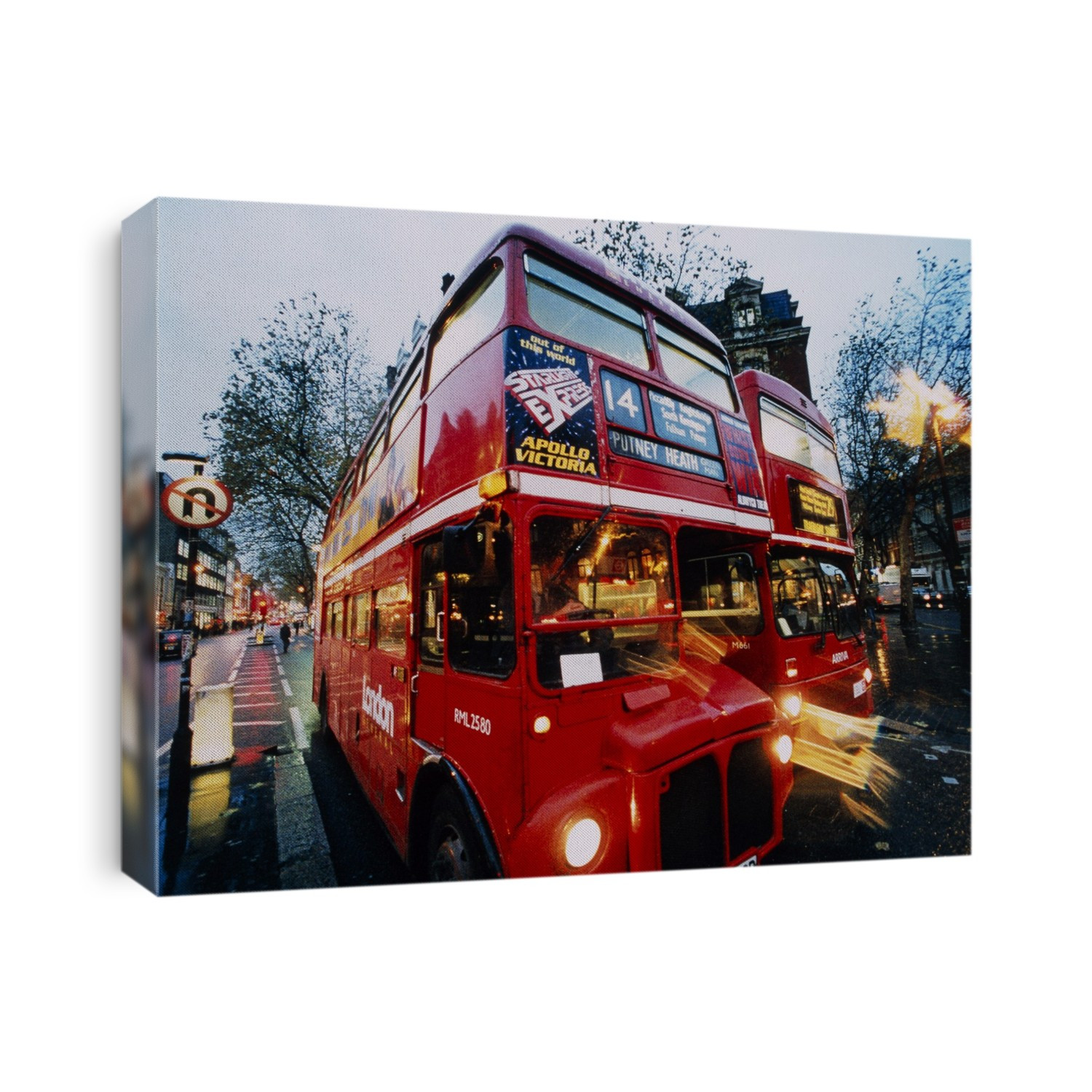 London buses. Time-exposure image of two Routemaster buses on a street in the early evening. Photographed in London, UK.