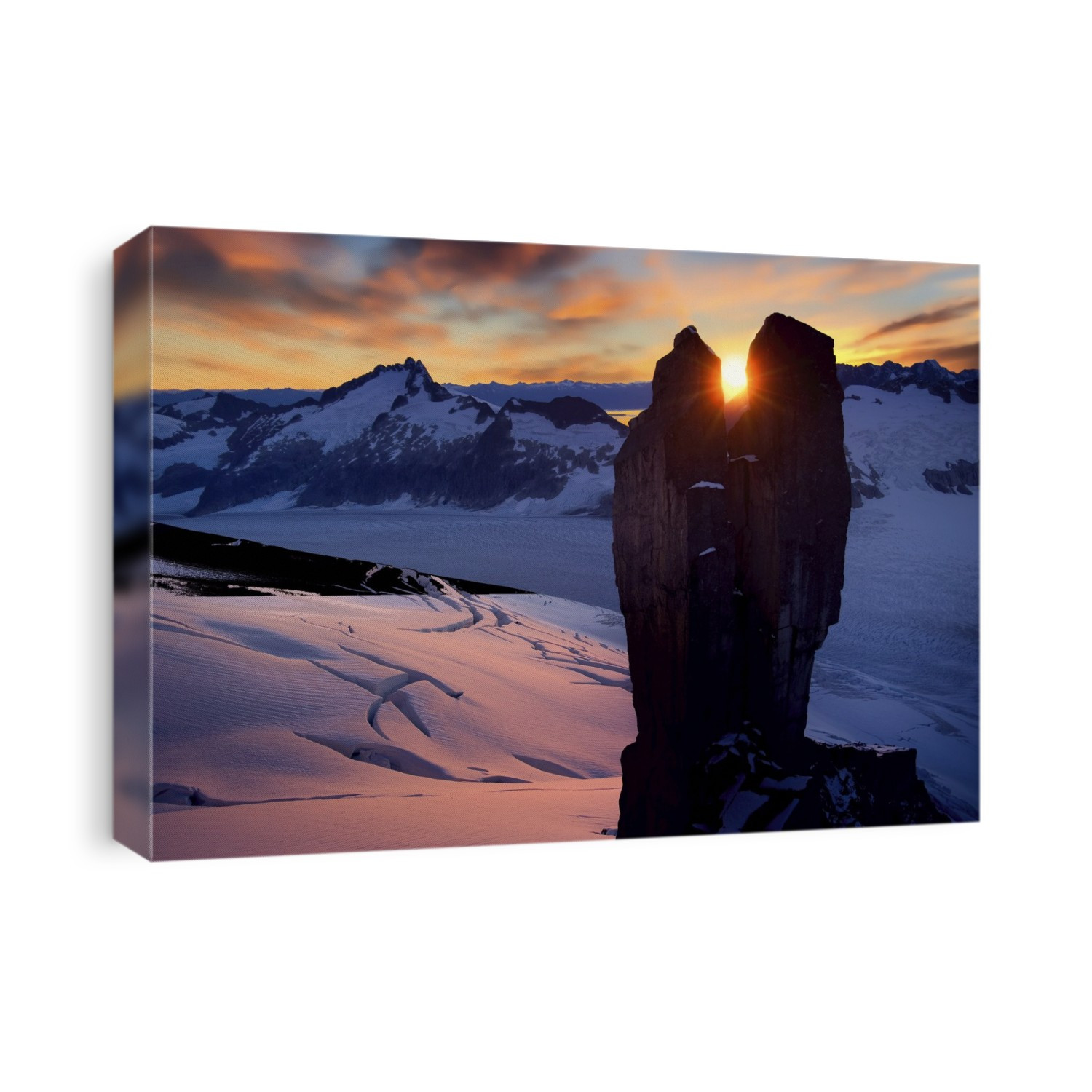 Looking through the Rabbit Ears rock spires of the Juneau Ice Field as the sun sets over the Chilkat Mountains with the Mendenhall Glacier below; Juneau, Alaska, United States of America