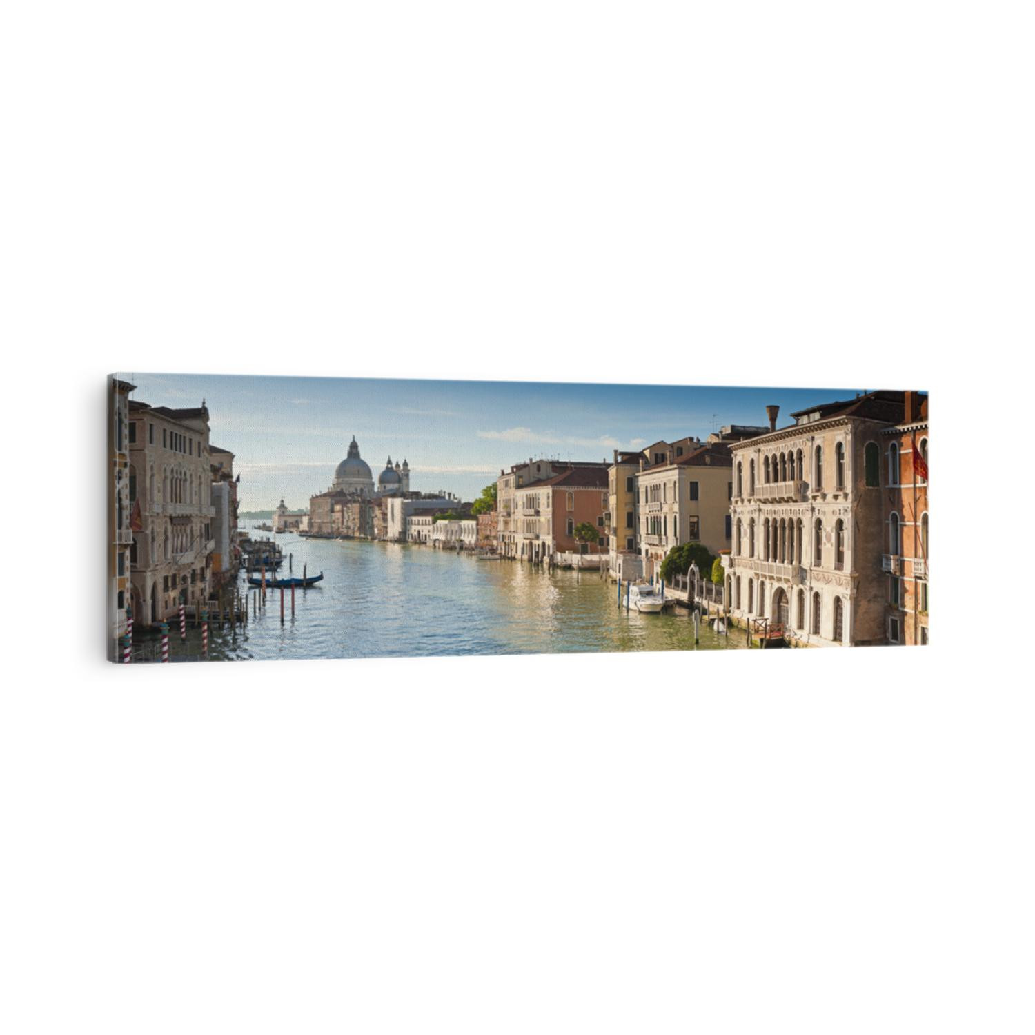 View of the Grand Canal and the stunning baroque Santa Maria Della Salute (1687) church in Venice and colourful villas bathed in early morning light. Stitched panoramic image.