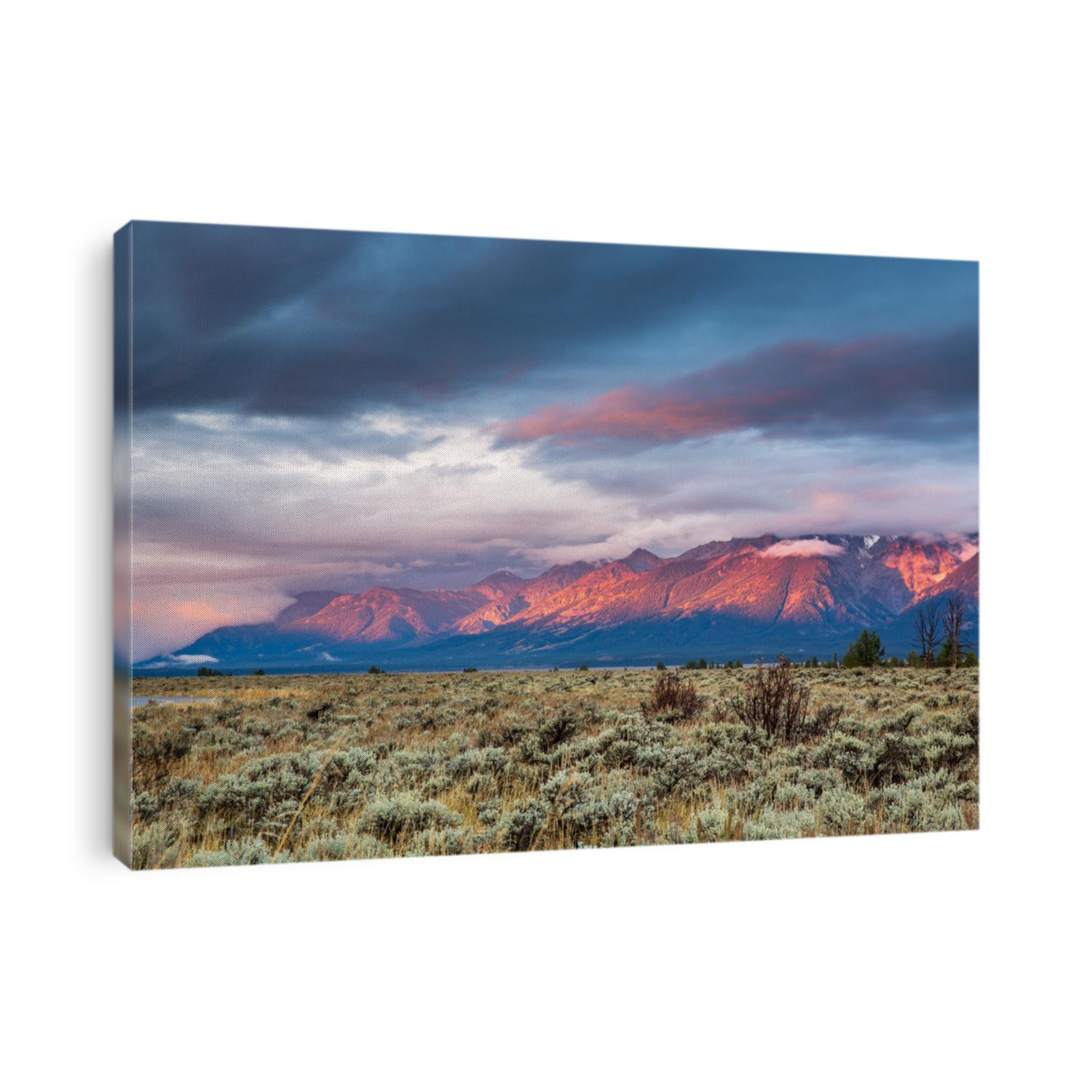 View of Grand Teton mountain range at sunrise.