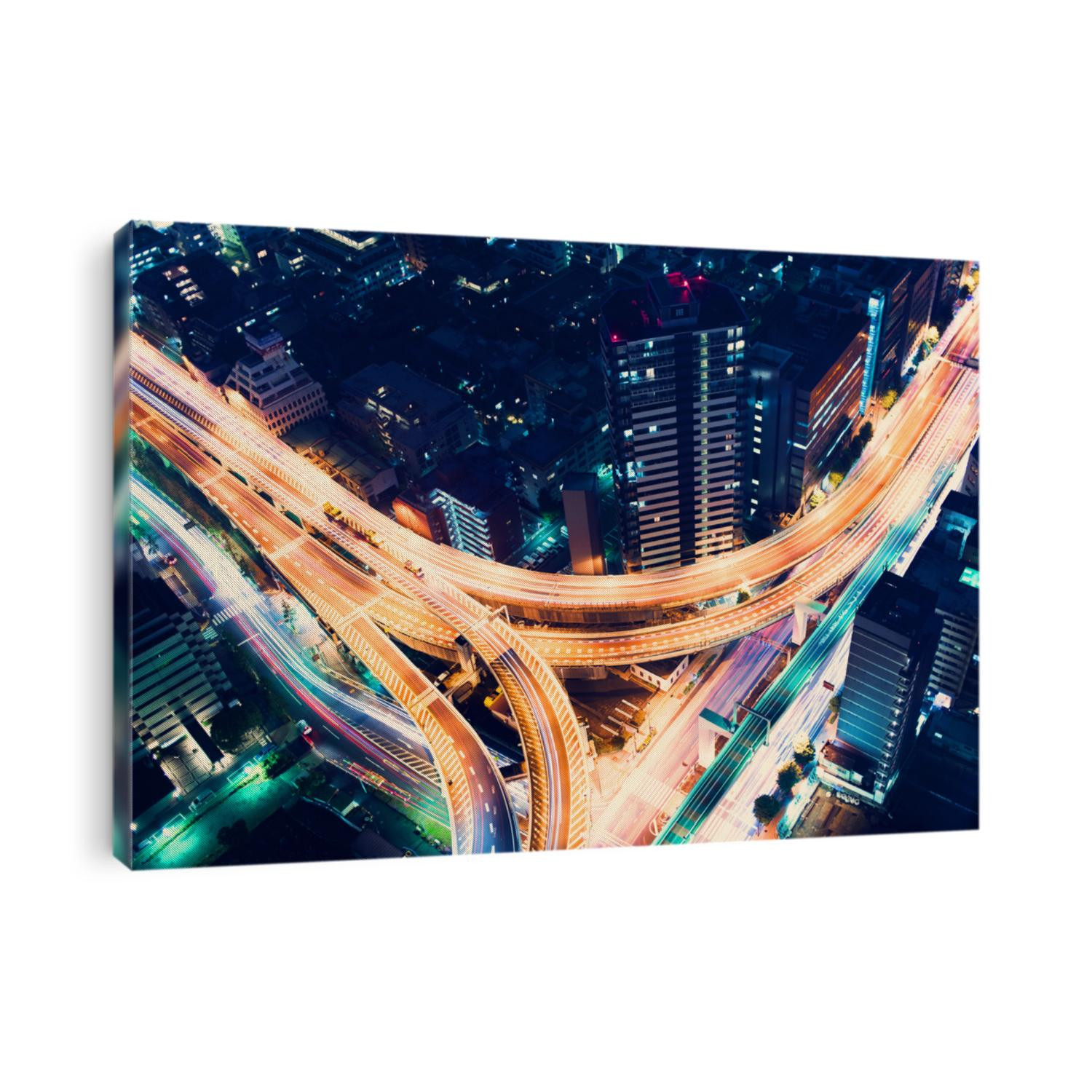 Aerial view of a massive highway intersection at night in Shinjuku, Tokyo, Japan