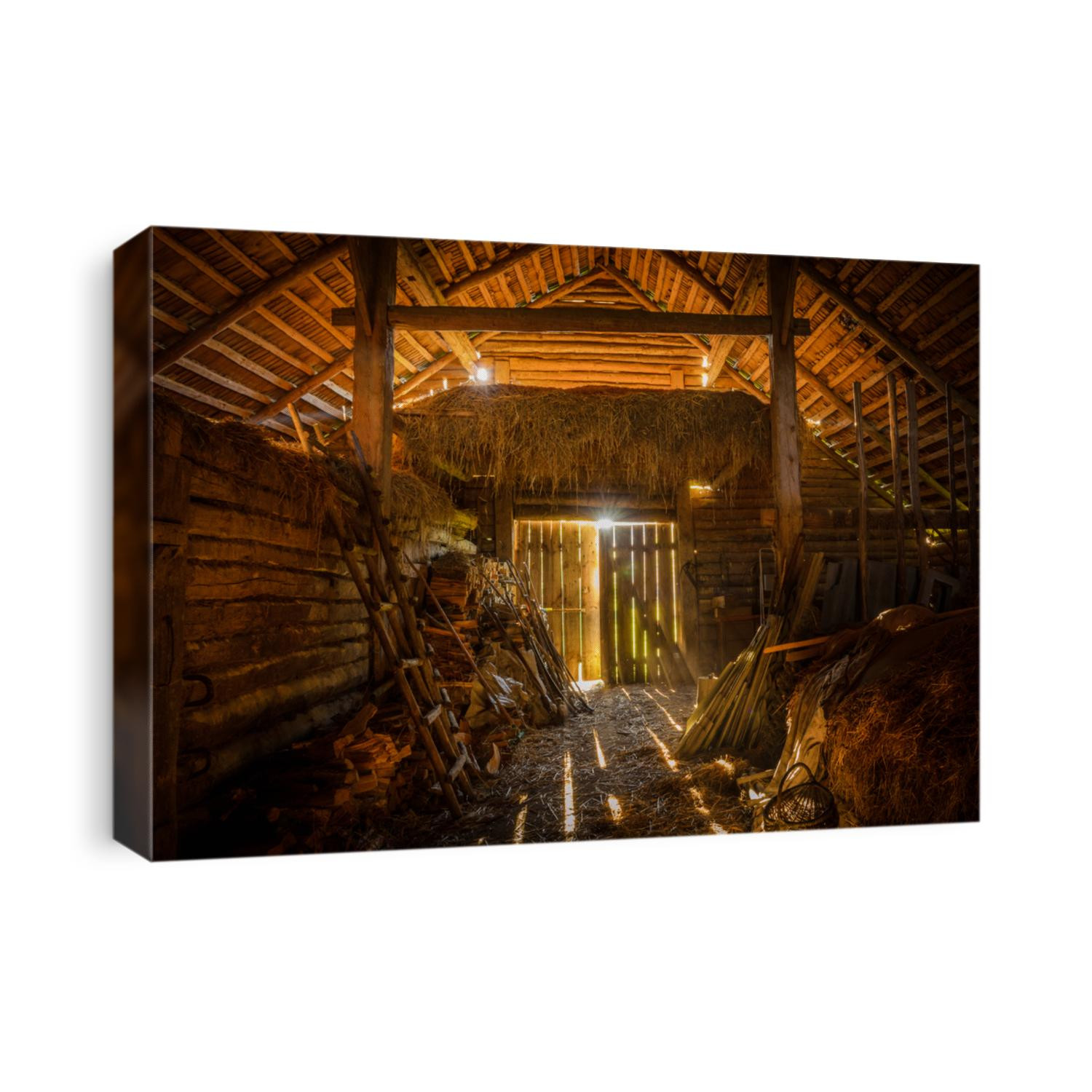 interior view of the old rural barn full of hay, firewood, tools and trash