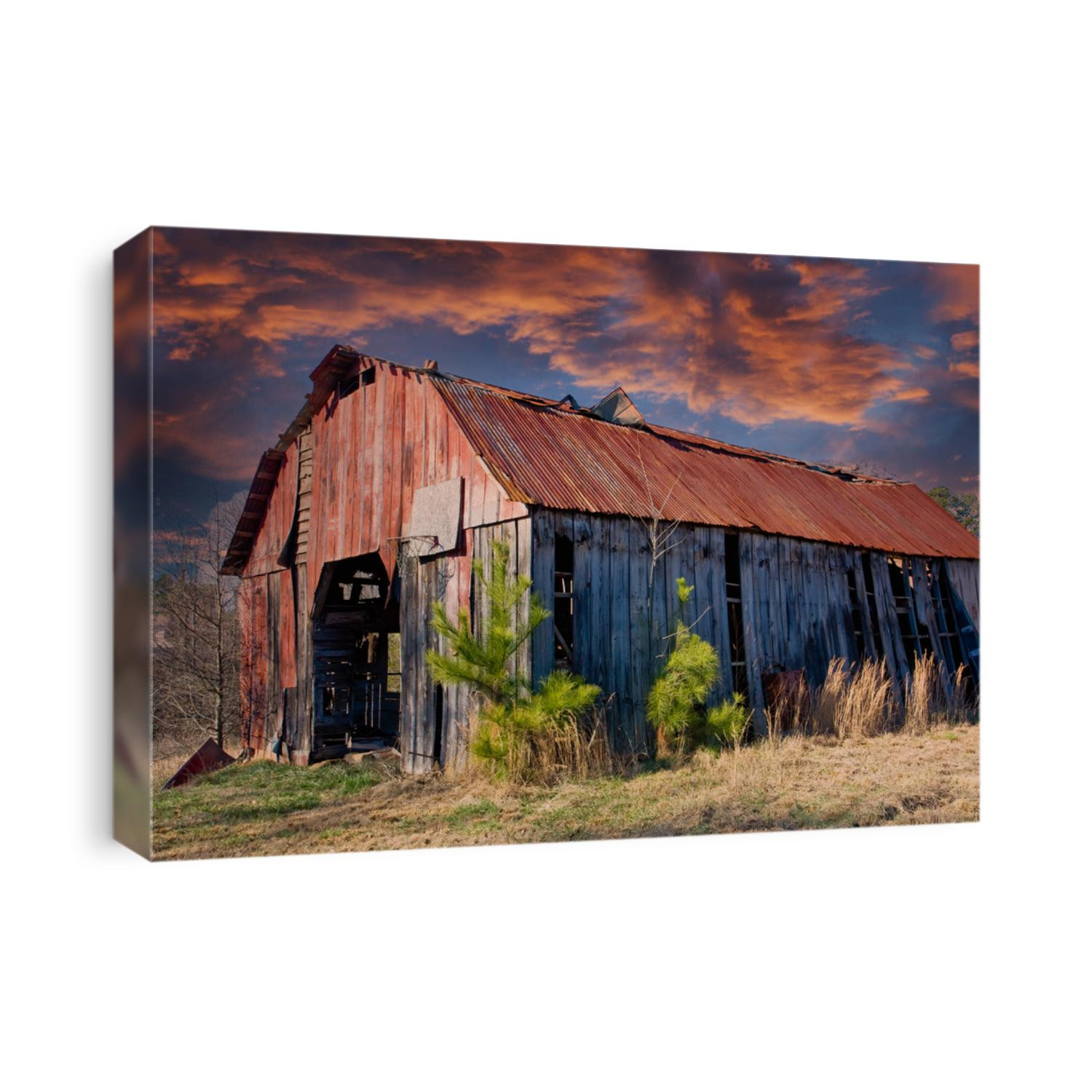 An old barn with a rusty roof in a rural area