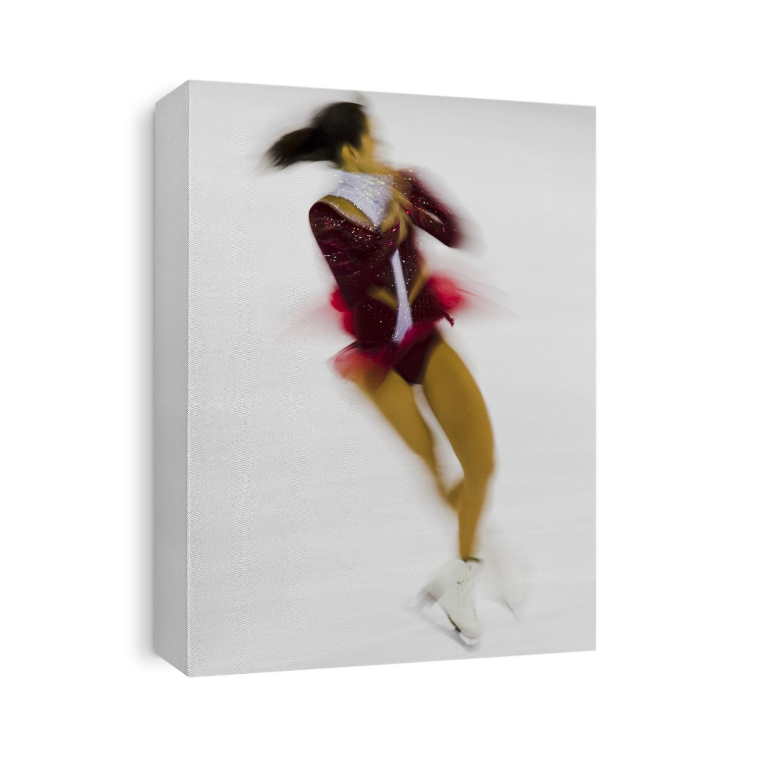 Blurred action of woman figure skater.