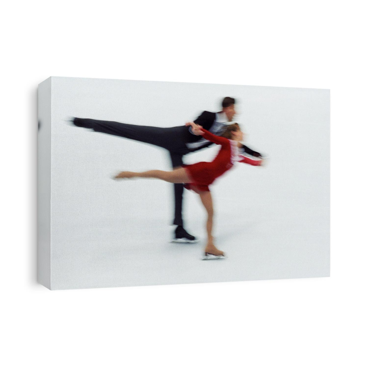 Blurred action of pairs figure skaters.
