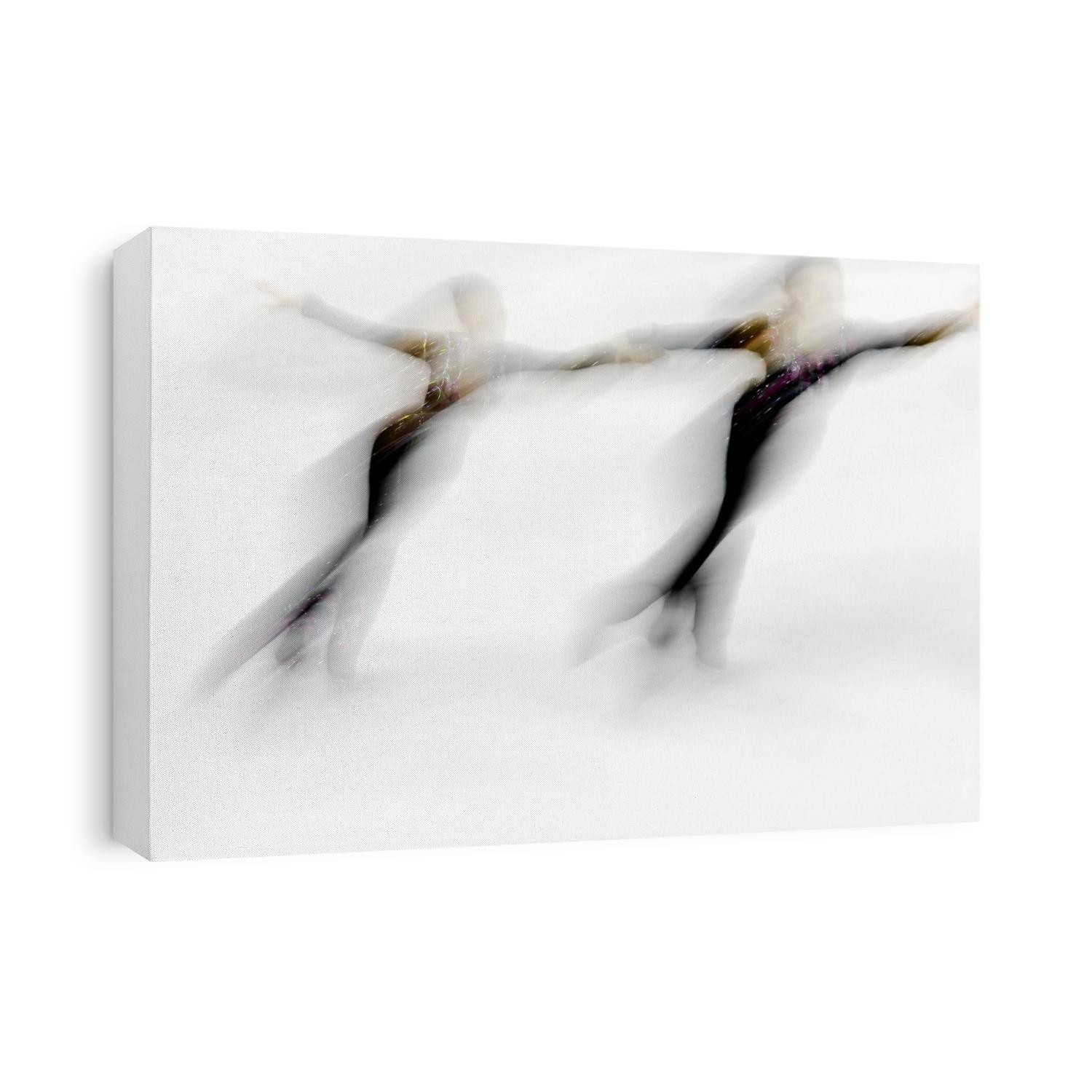 Blurred action of pairs figure skaters.
