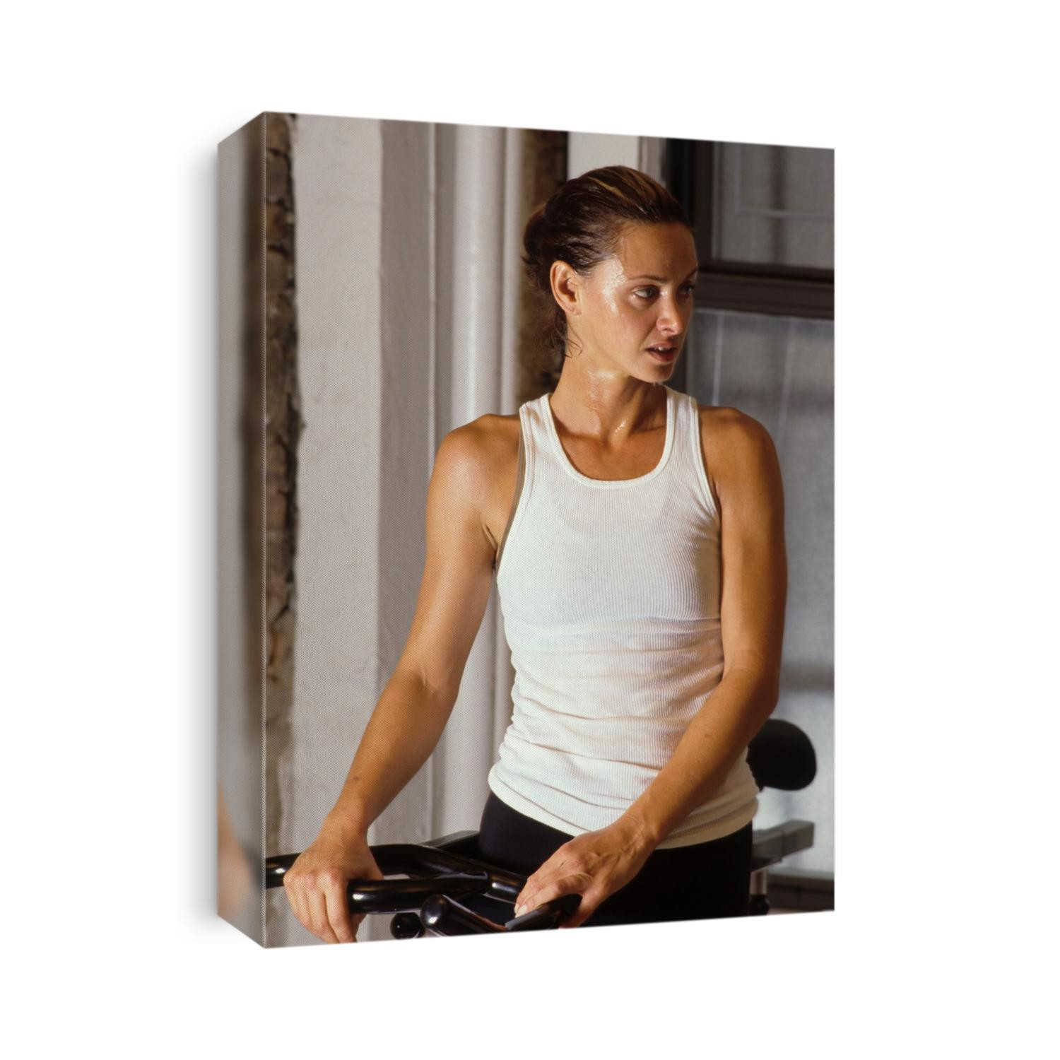 Woman resting after exercising on stationary bike.