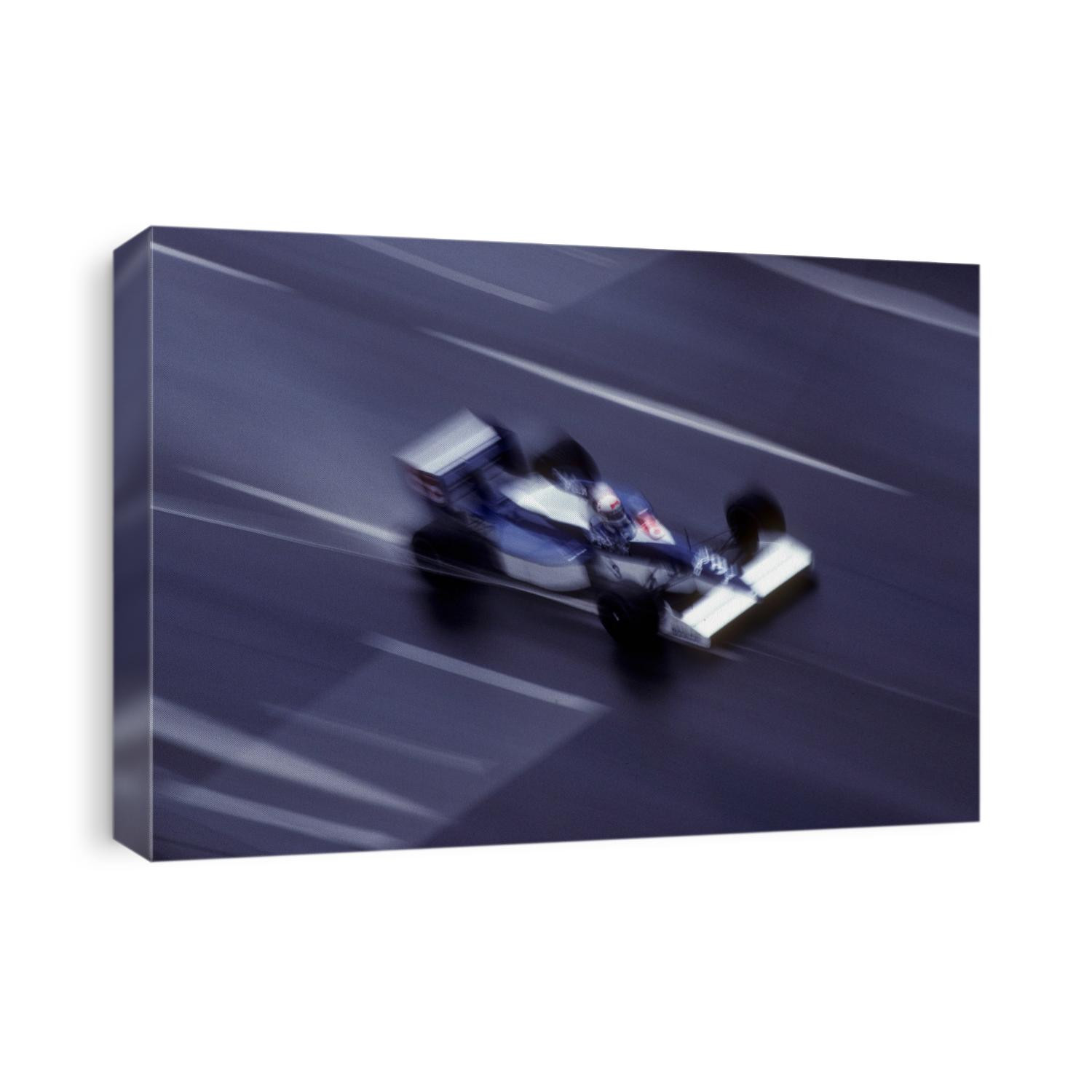 Blurred F1 auto racing action.
