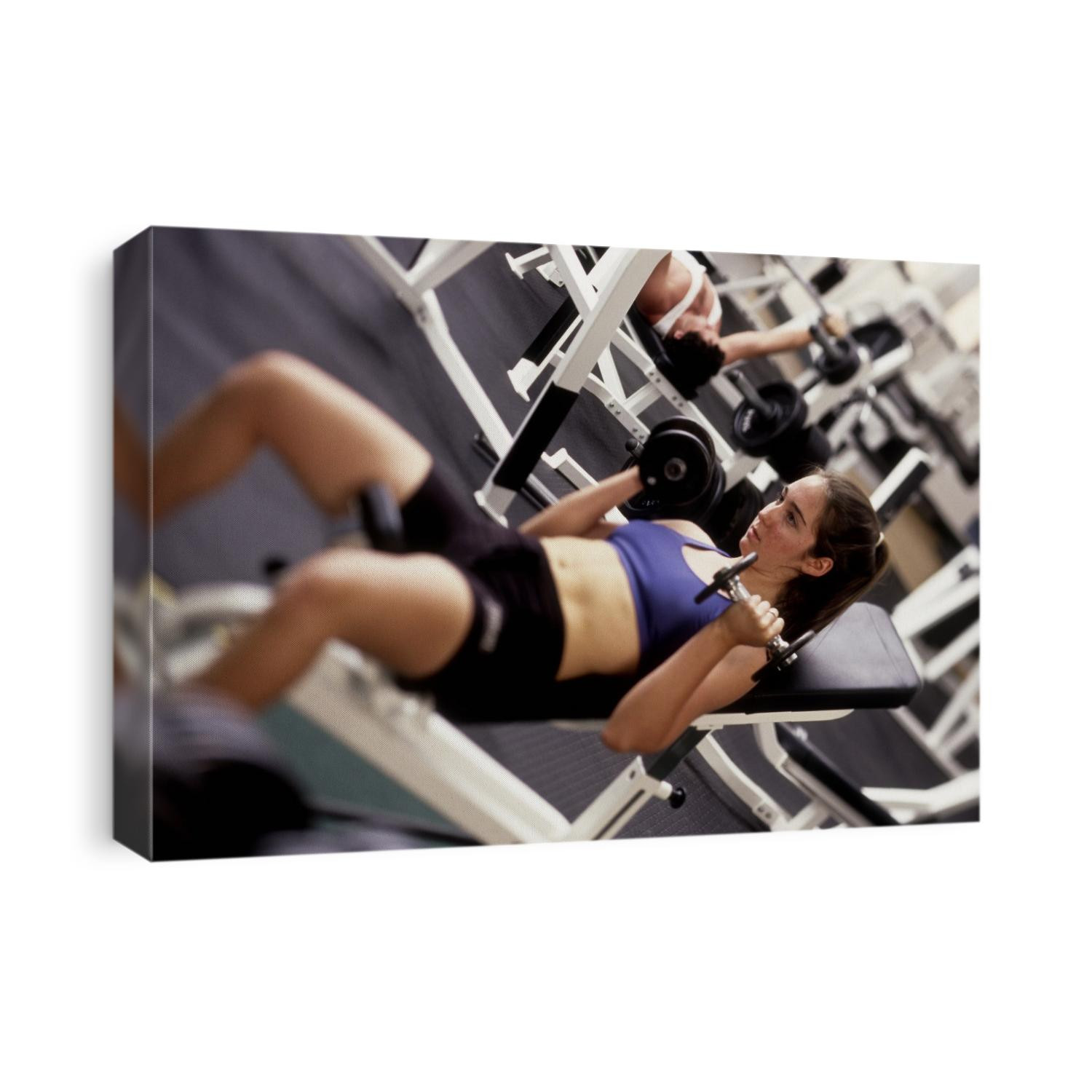 Young woman working out with hand weights,