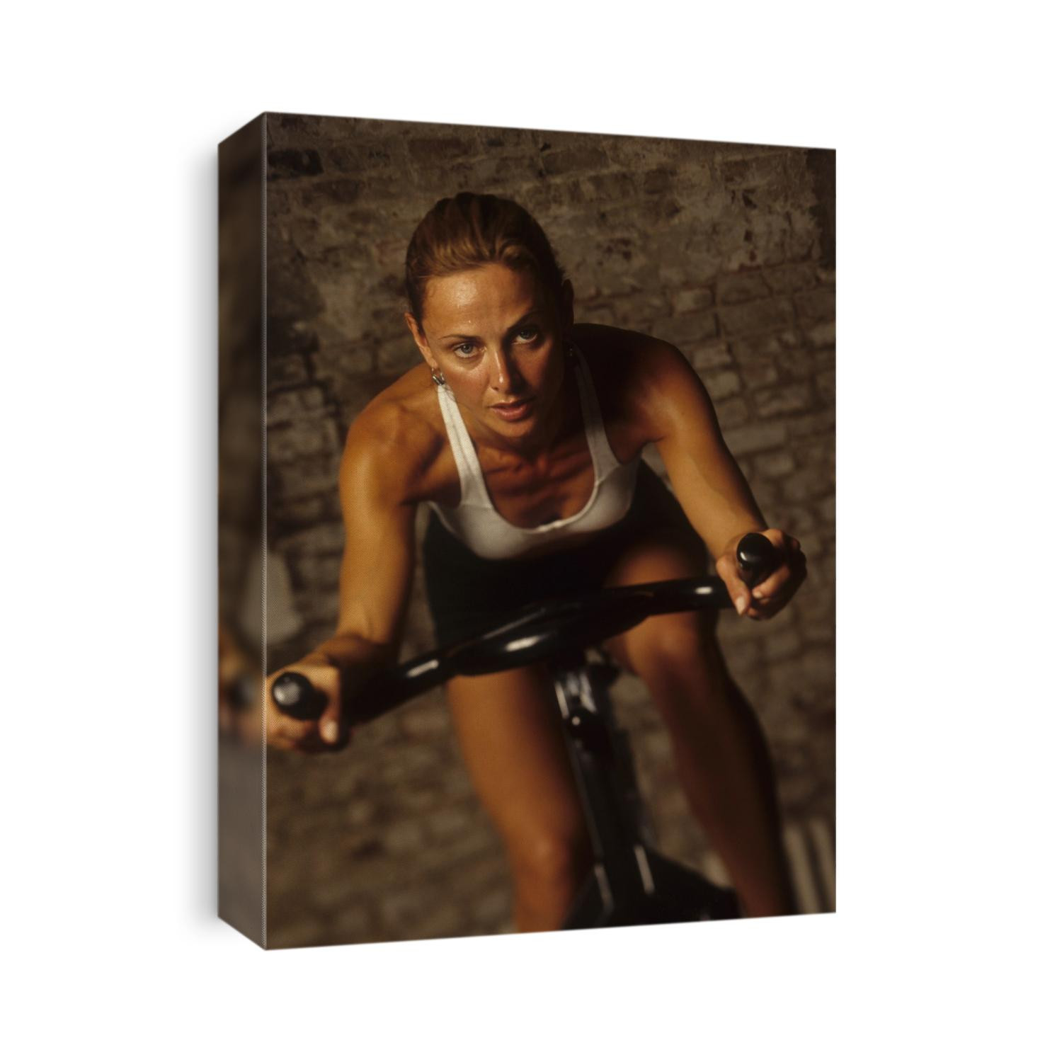 Young woman exercising on a stationary bike.