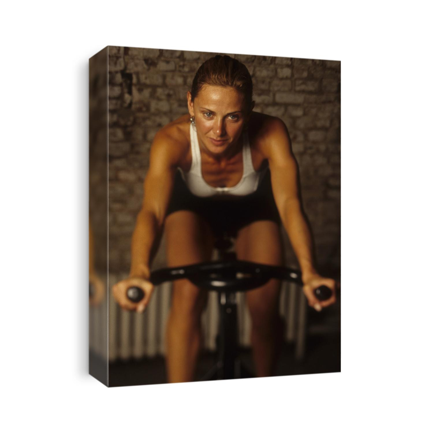 Young woman exercising on a stationary bike.