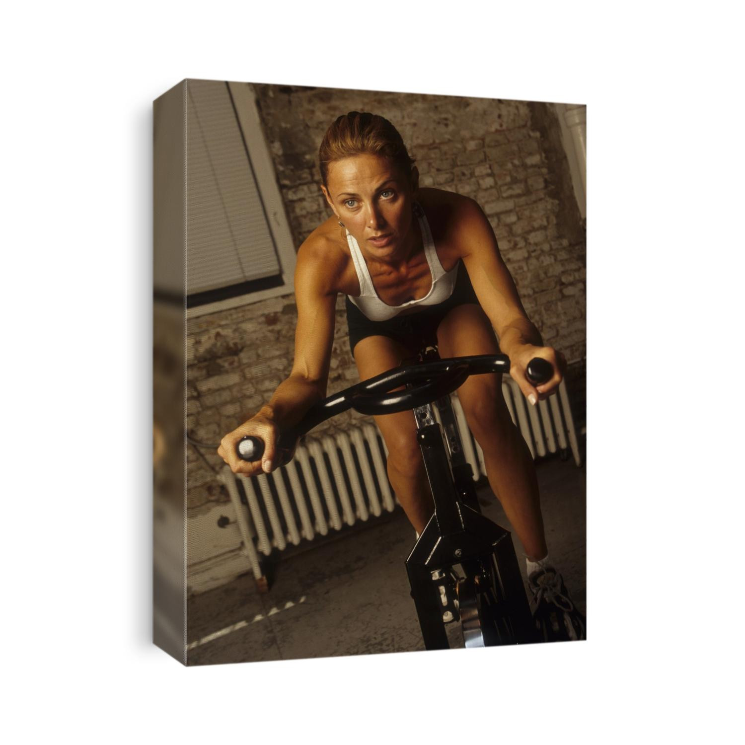 Young woman exercising on a stationary bike.