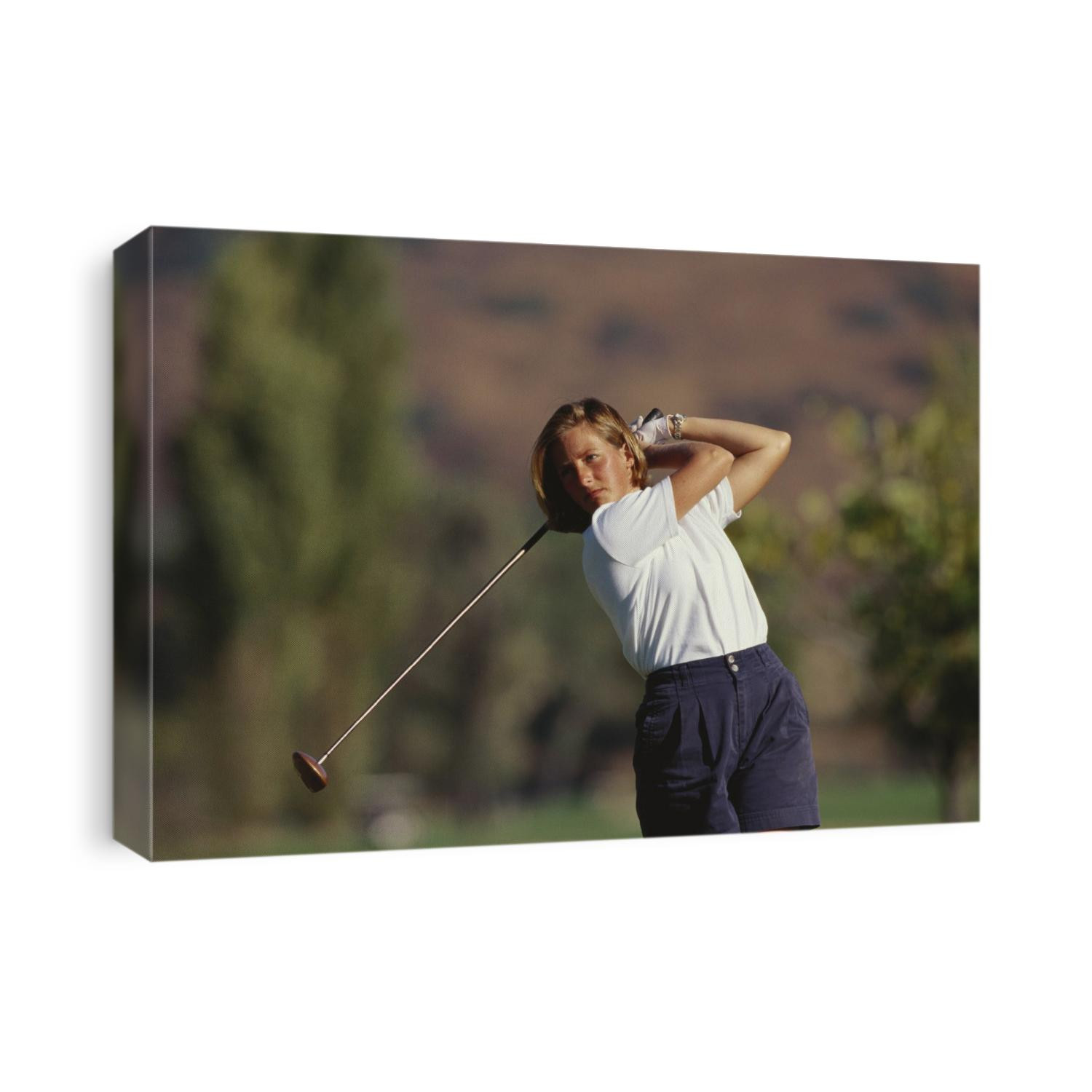 Woman golfer in action.