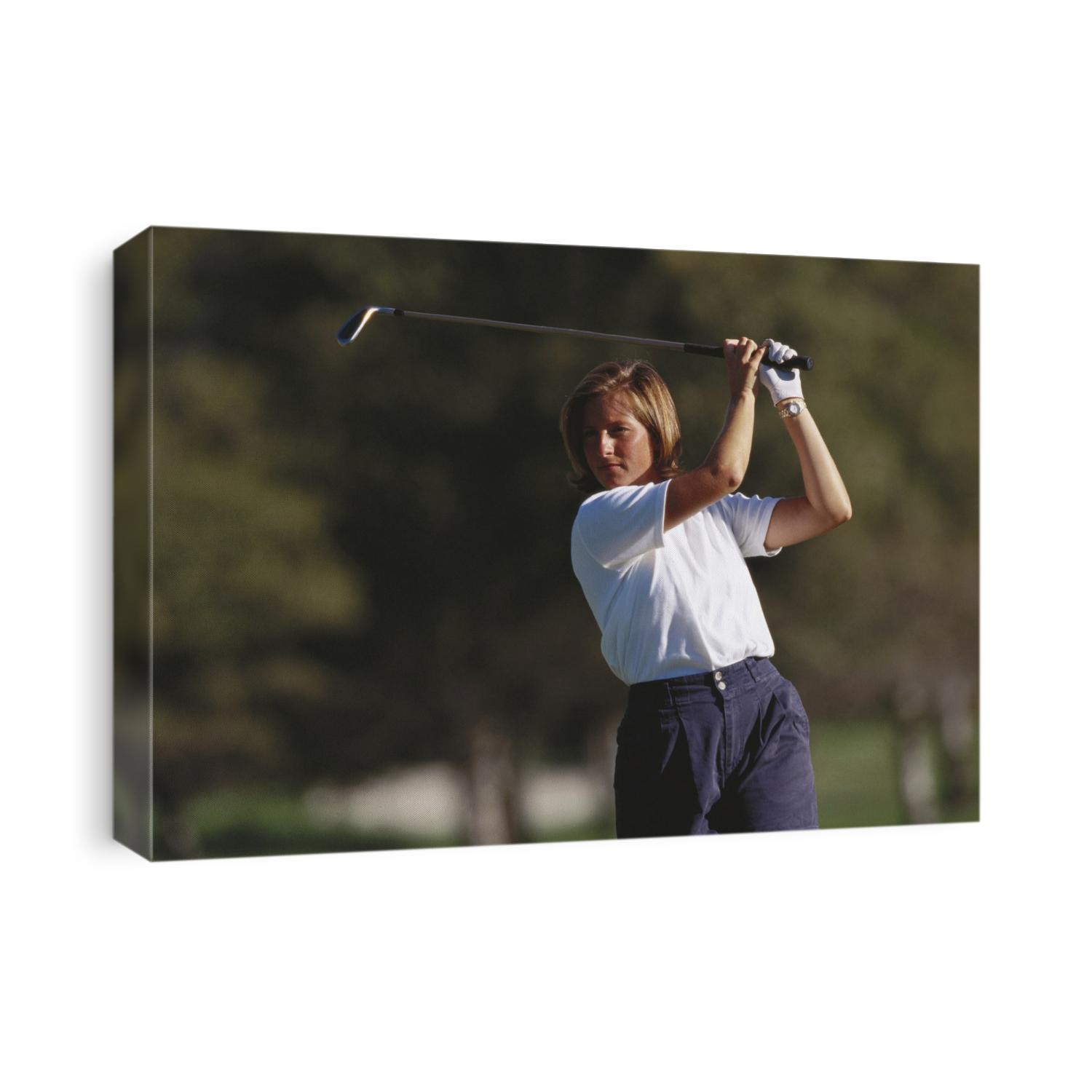 Woman golfer in action.