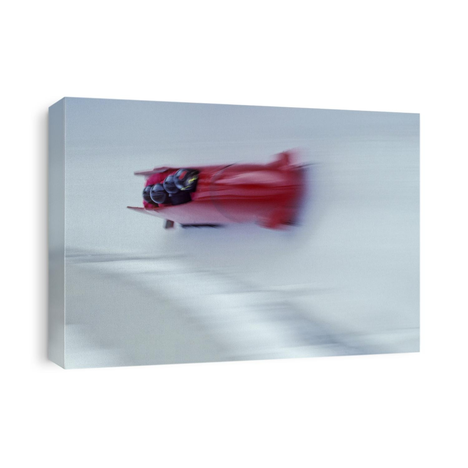 Blurred action of 4 man bobsled team