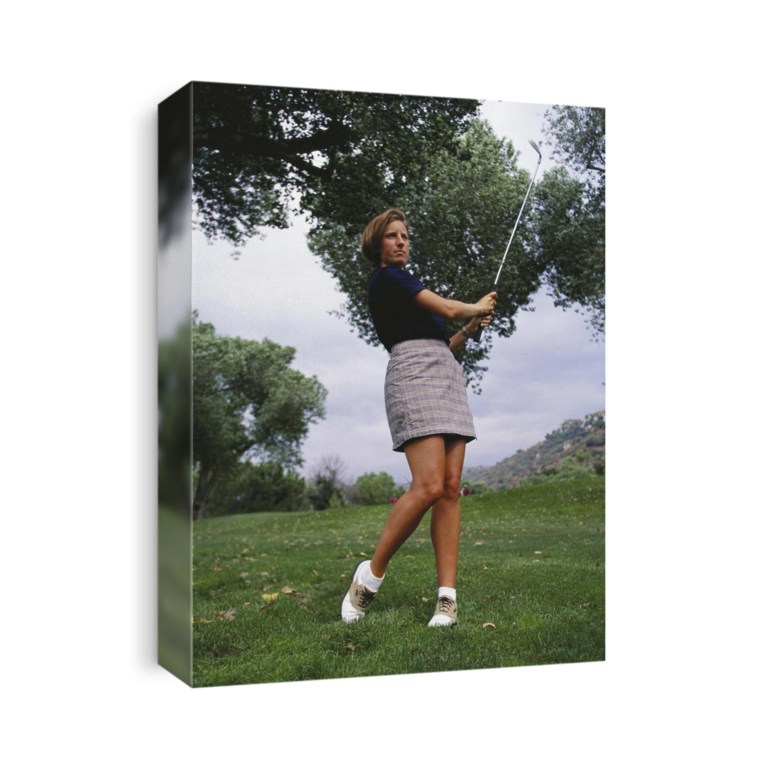 Woman golfer in action.