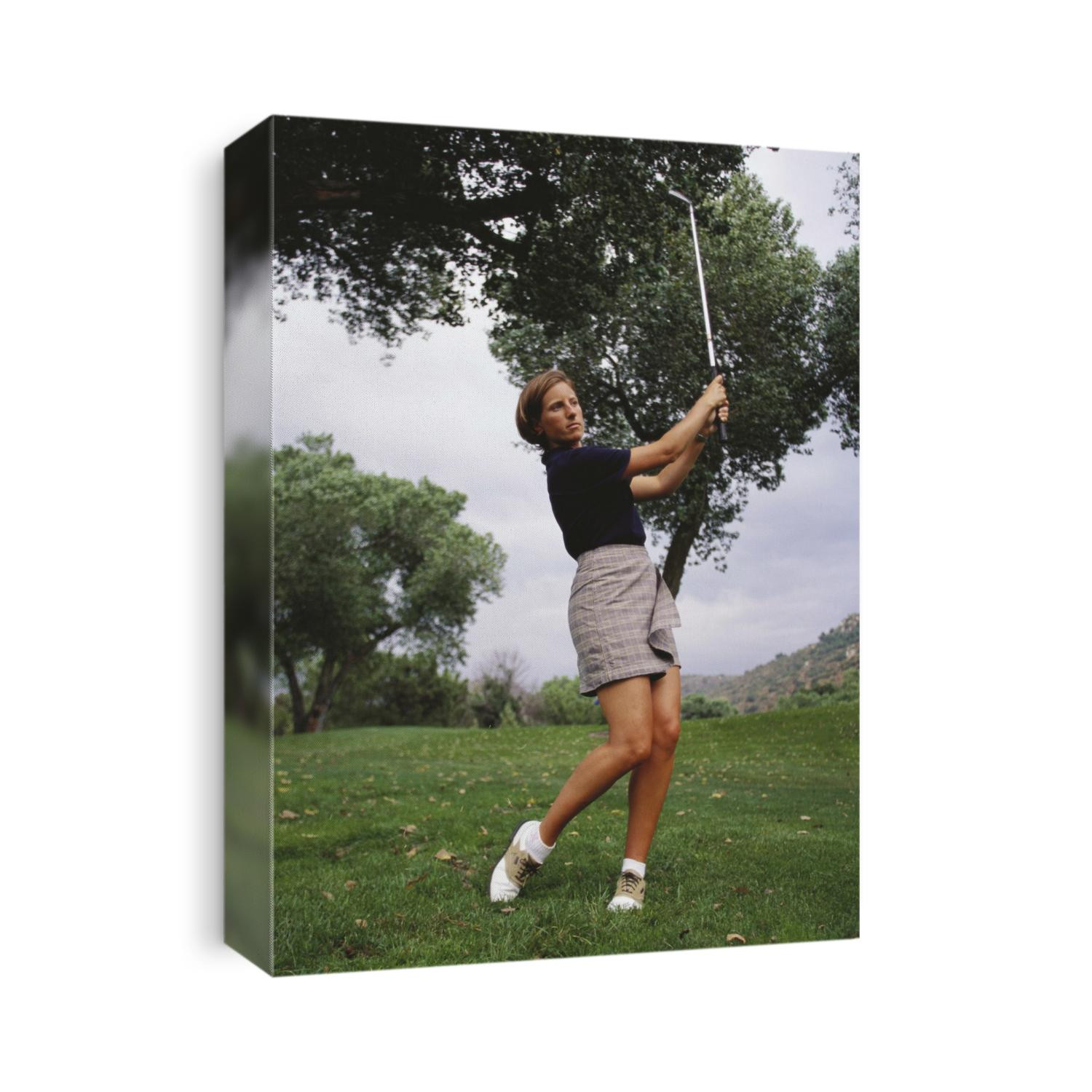 Woman golfer in action.