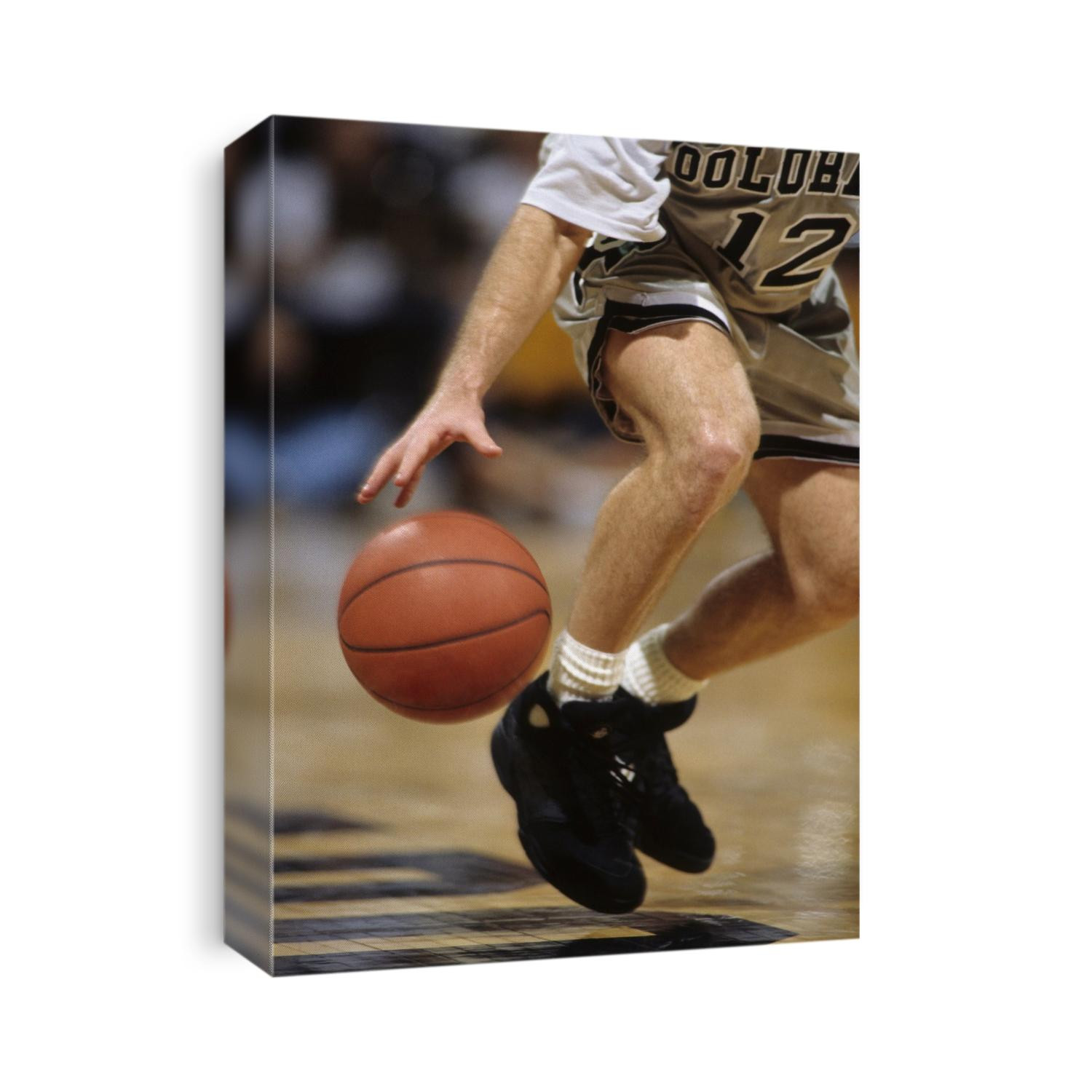 Detail of male basketball player dribbling the ball