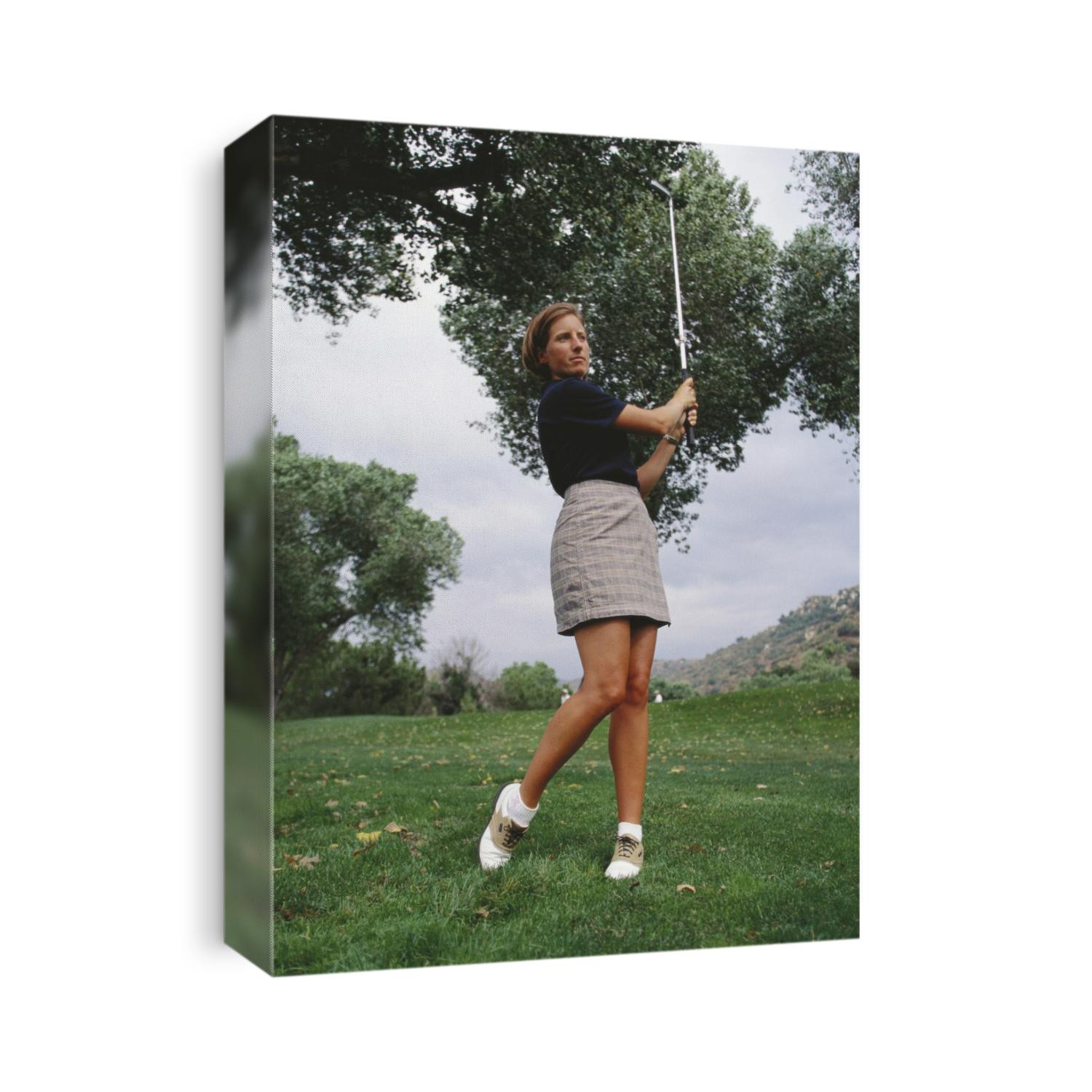 Woman golfer in action.