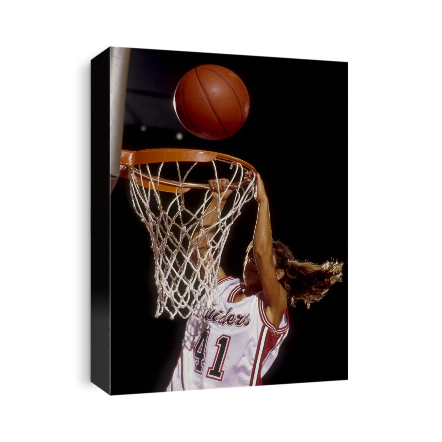 Female basketball player slam dunking.