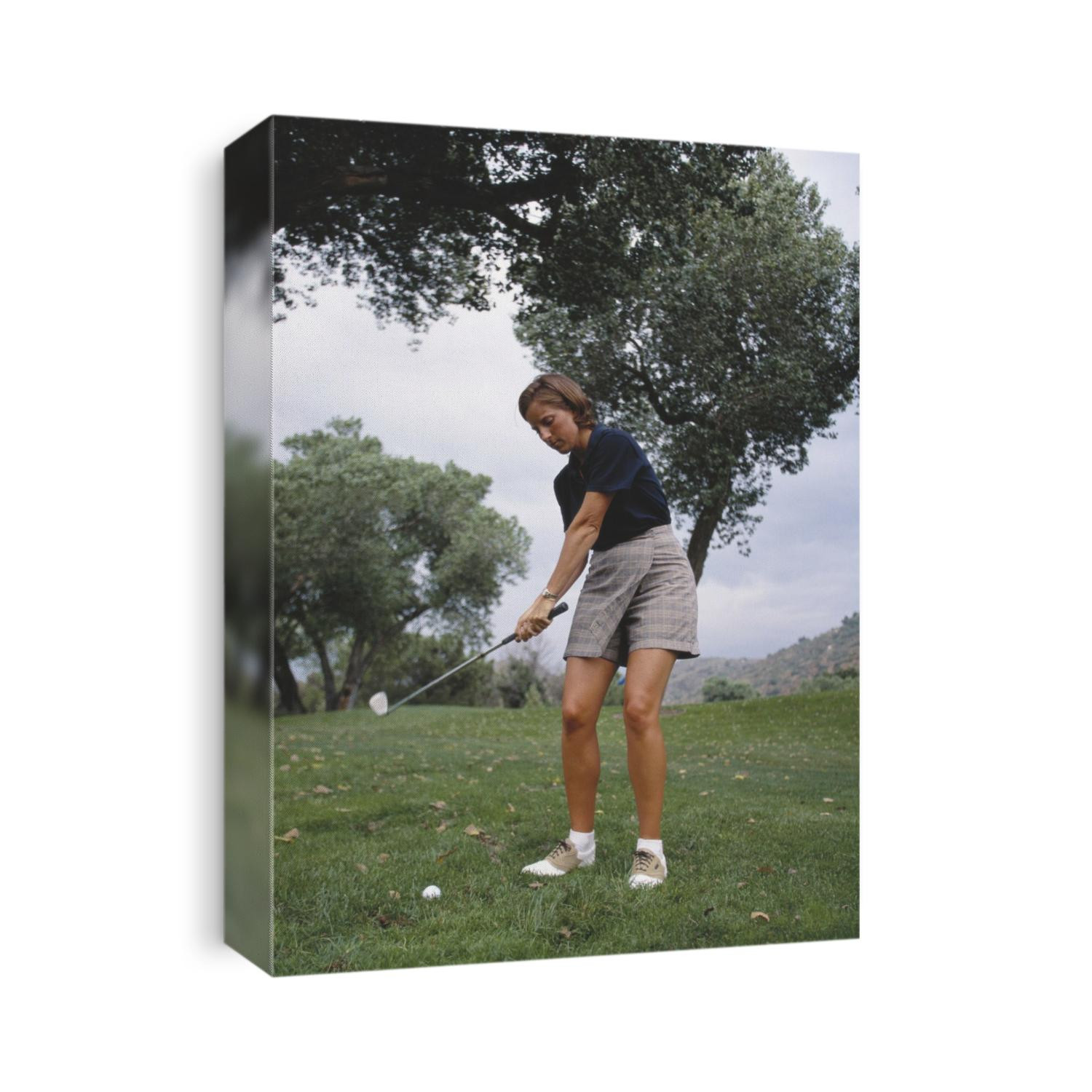 Woman golfer in action.