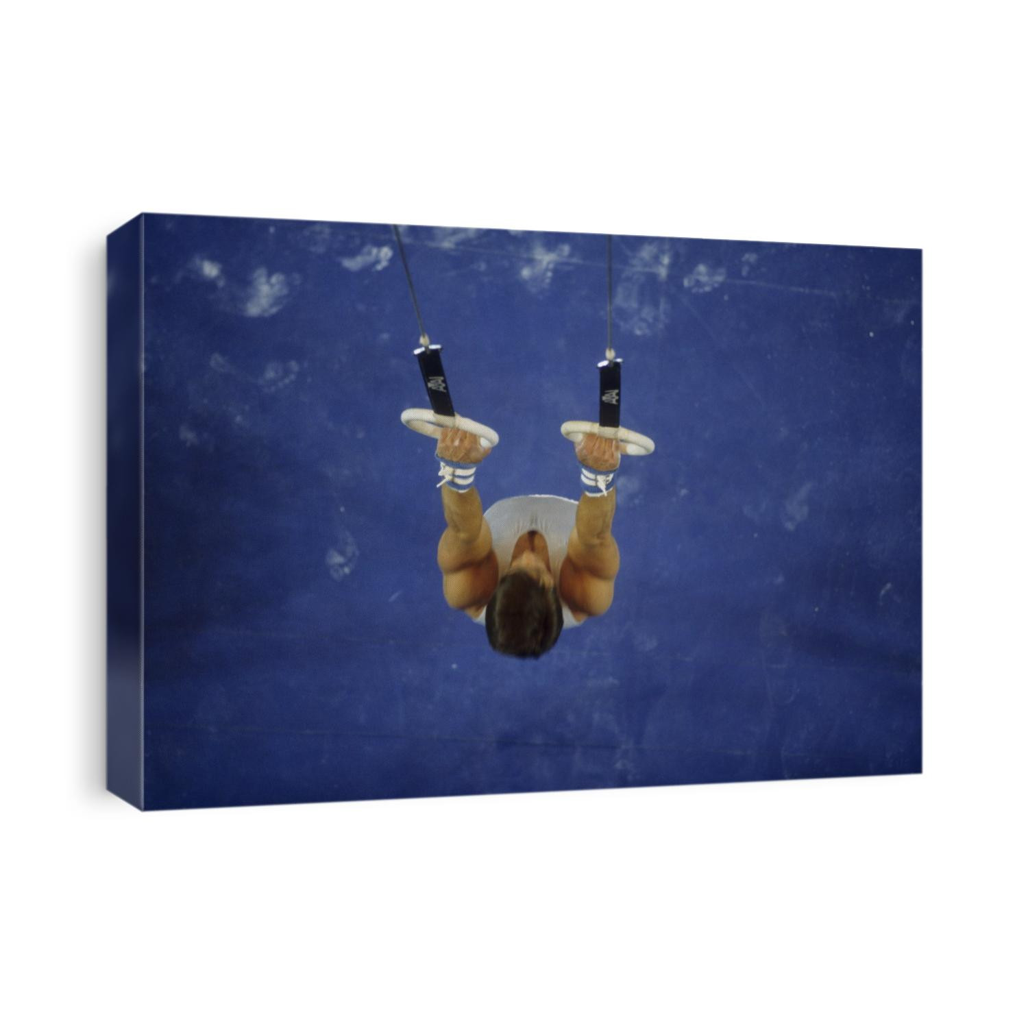 Male gymnast on the rings.