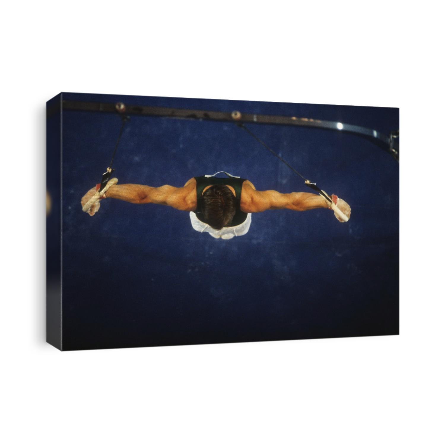 Male gymnast on the rings.