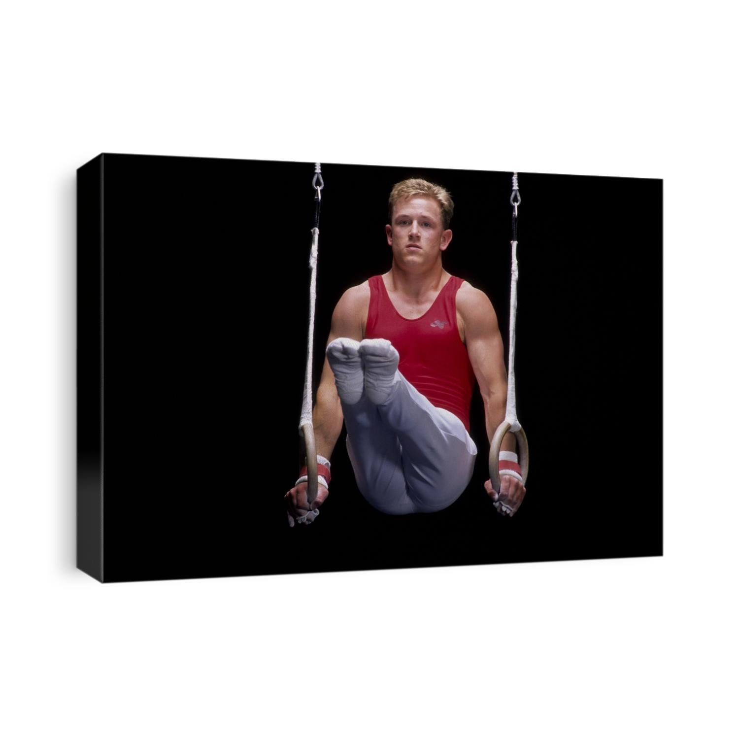 Male gymnast on the rings.
