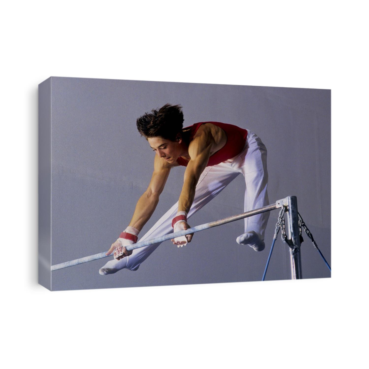 Male gymnast performing on the horizontal bar.