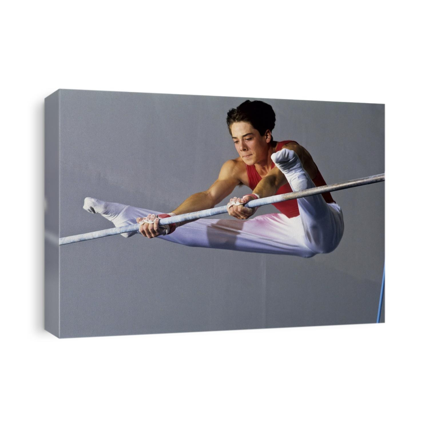 Male gymnast performing on the horizontal bar.