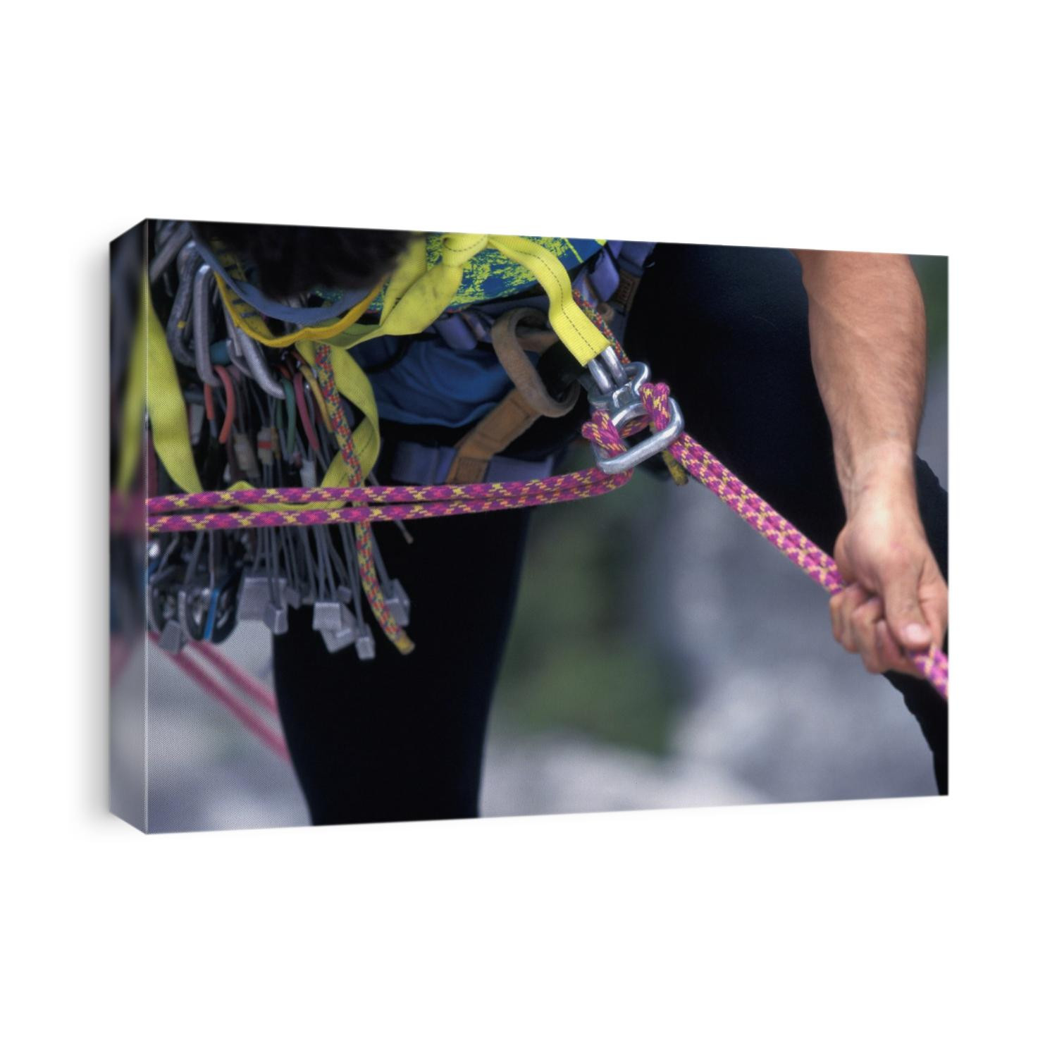 Detai of rock climber with his rope.