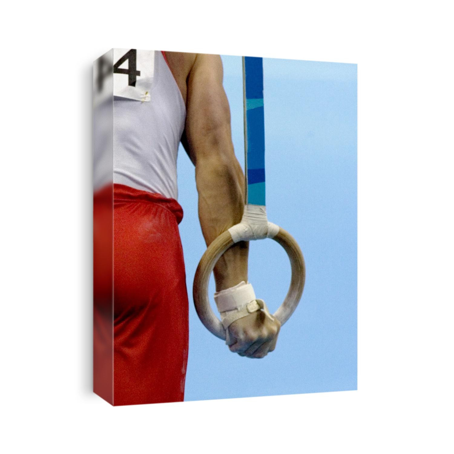 Detail of male gymnast competing on the rings.